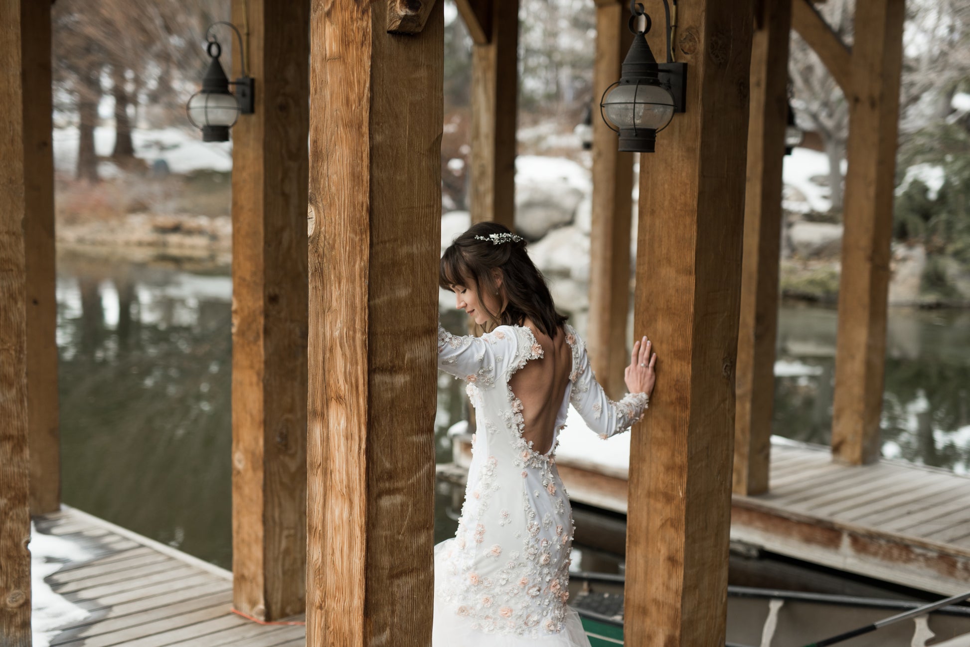 ¾ angled view of the lydia gown on a bride, showing the Mermaid silhouette gown with scoop back and long sleeves. The gown is shown here in satin, the crepe version would just be more matte.