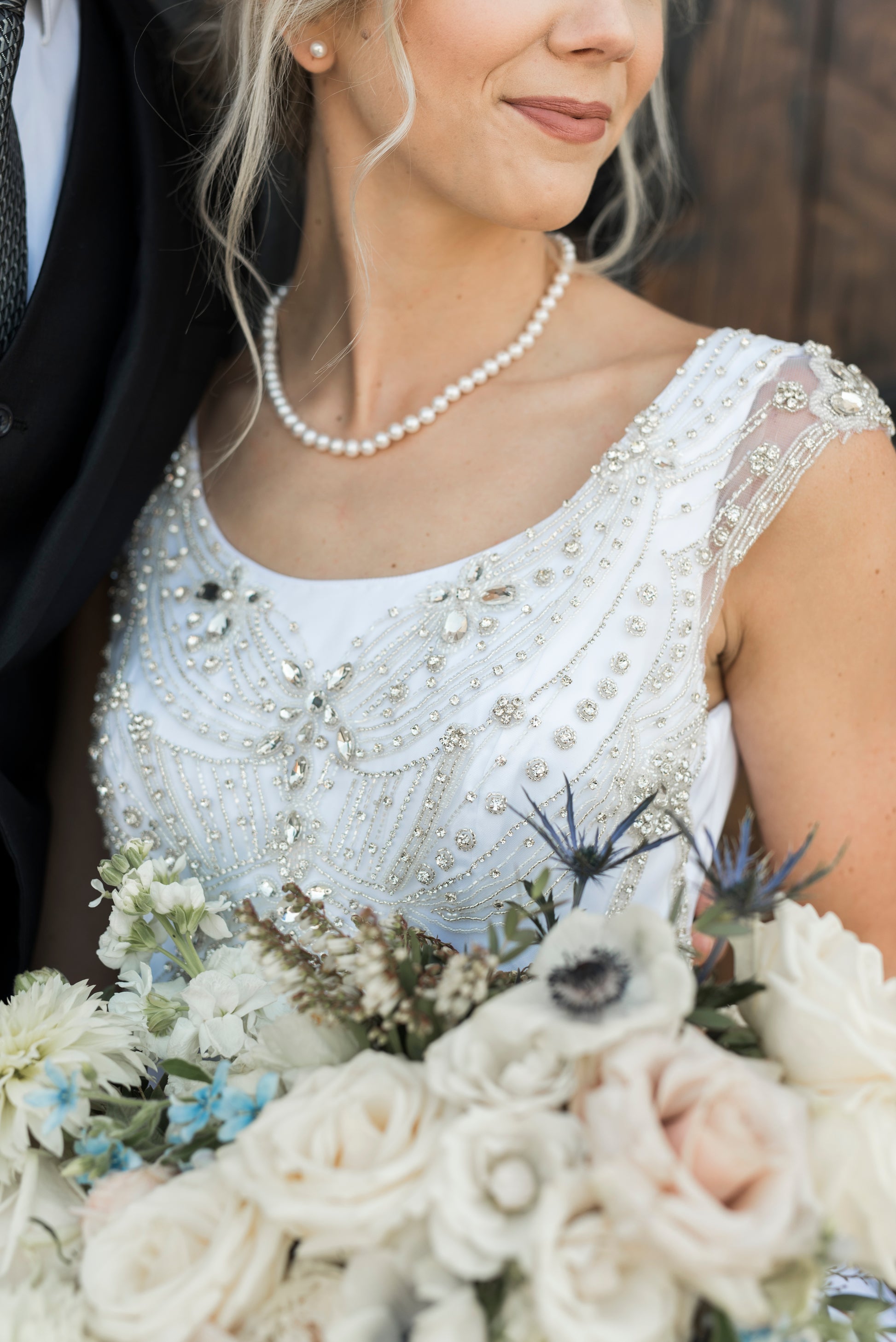 Macro detail of rhinestones scattered across bodice and cap sleeves