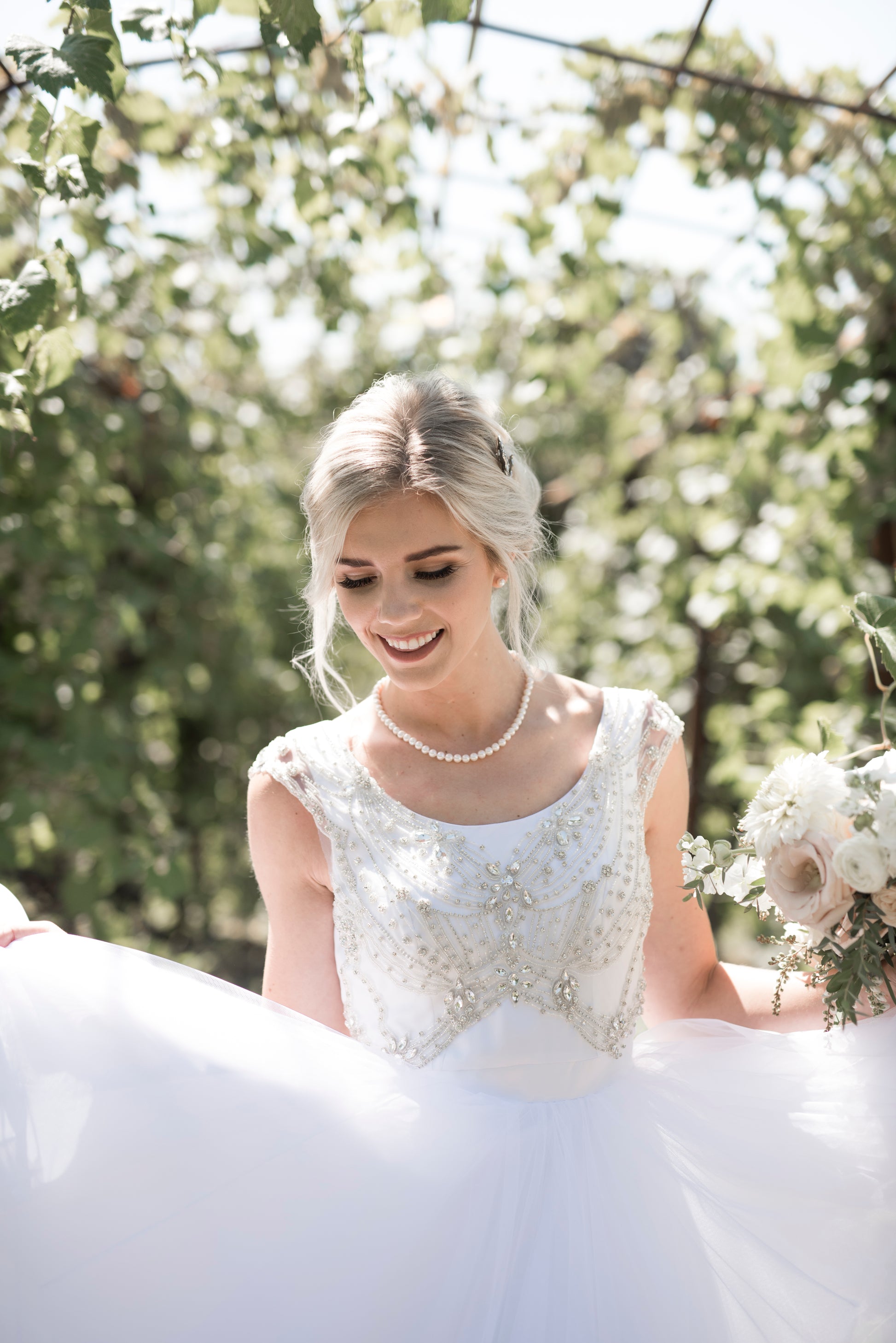 Bride dancing in Georgia gown, showing movement of tiered tulle skirt.