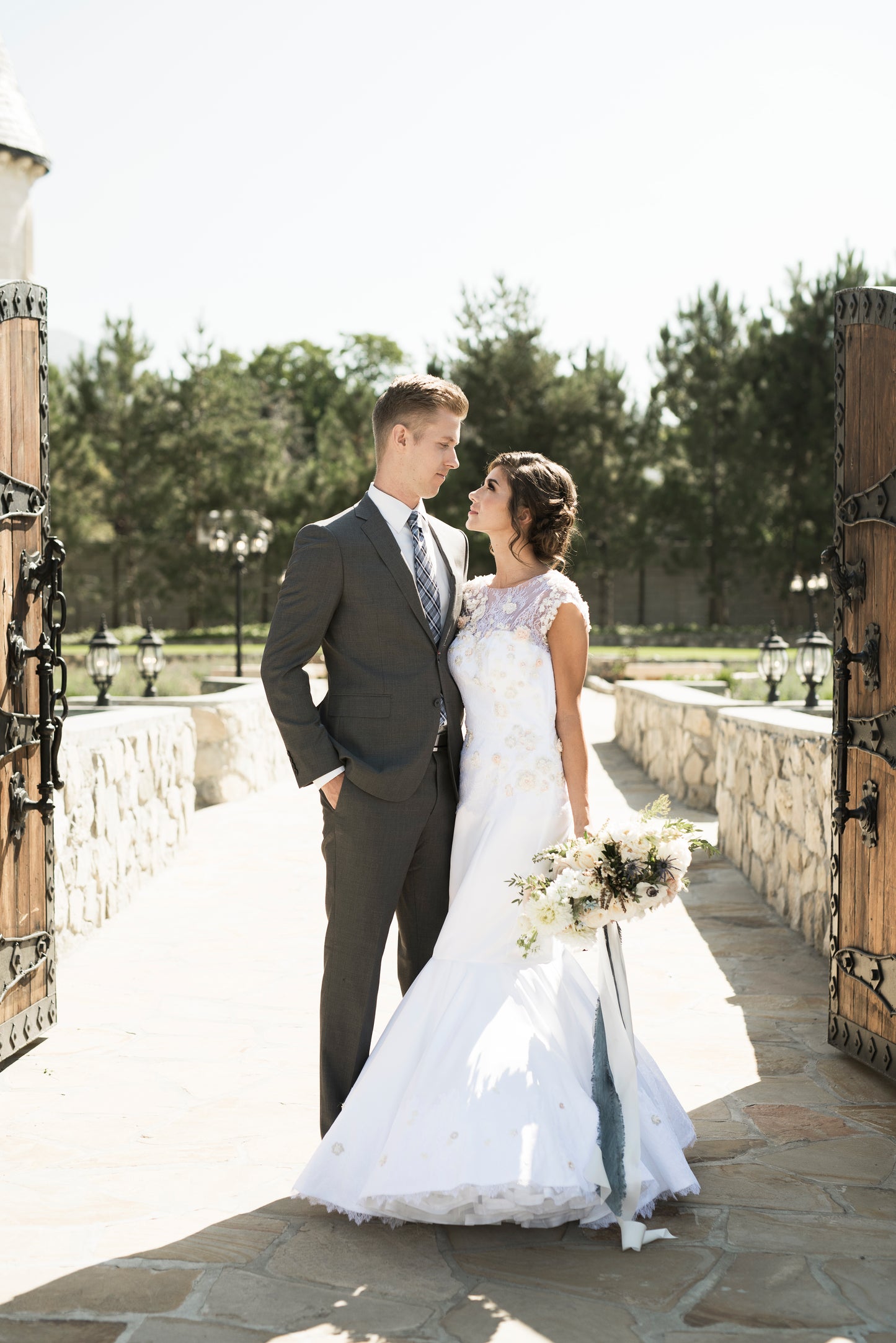 A full length view of the 3d floral lace Naomi gown, in blush / white satin.