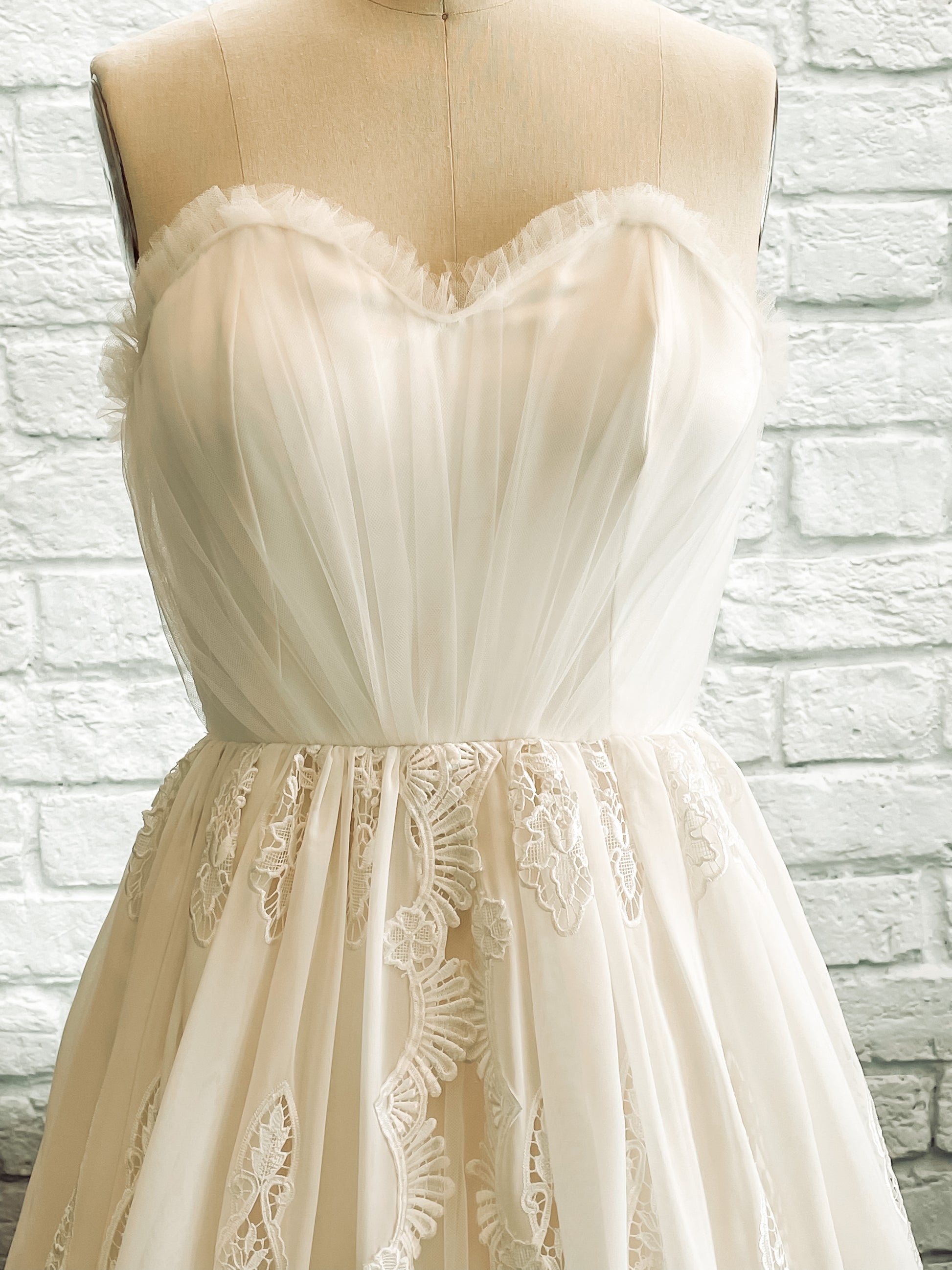 Close-up of Nerissa gown's gathered tulle bodice with soft scoop sweetheart neckline