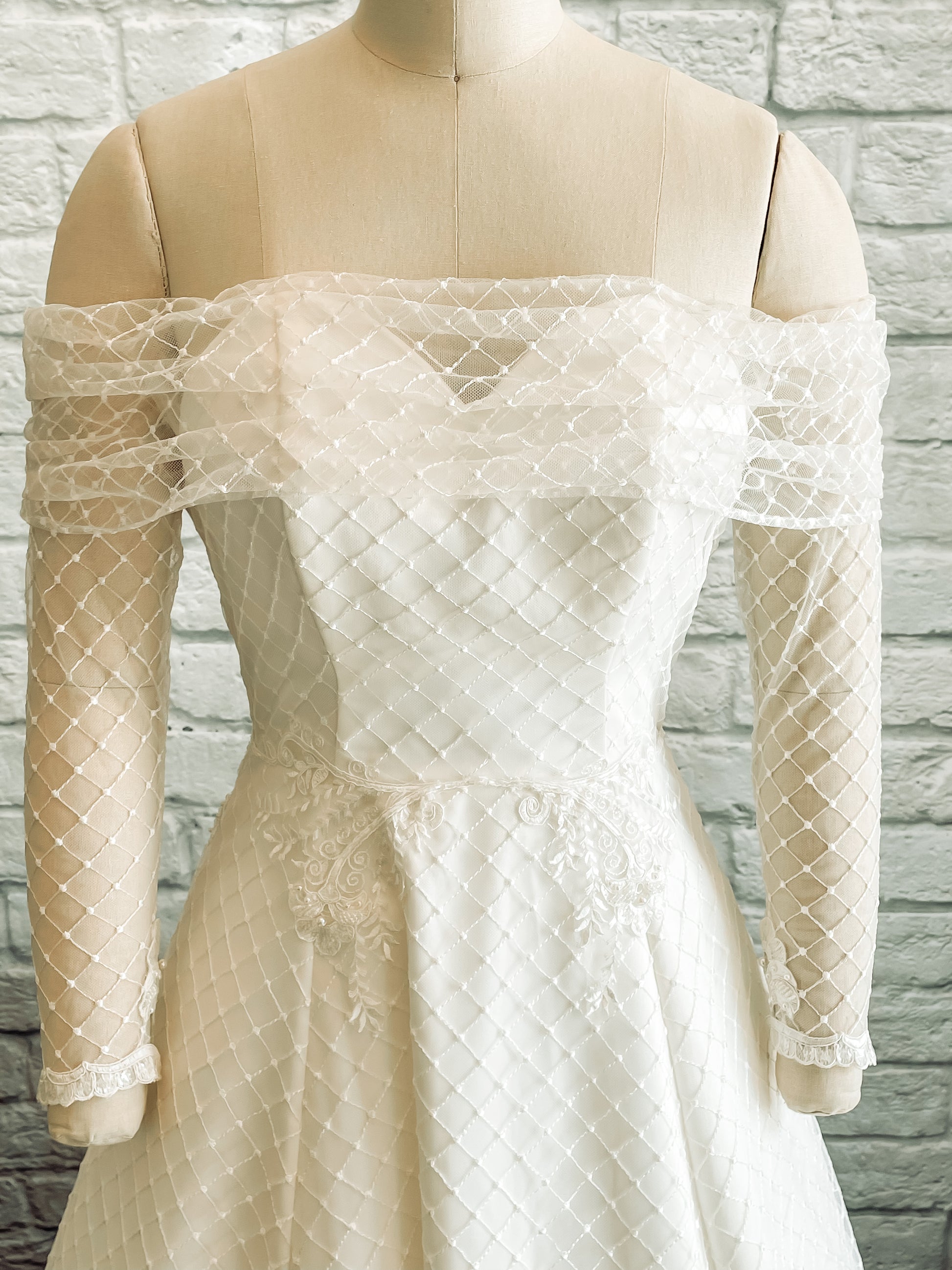 A close up of the Virginia front bodice; the photo shows off the embroidered diamond tulle over structured satin bodice with boning, bra cups and an internal bra strap.