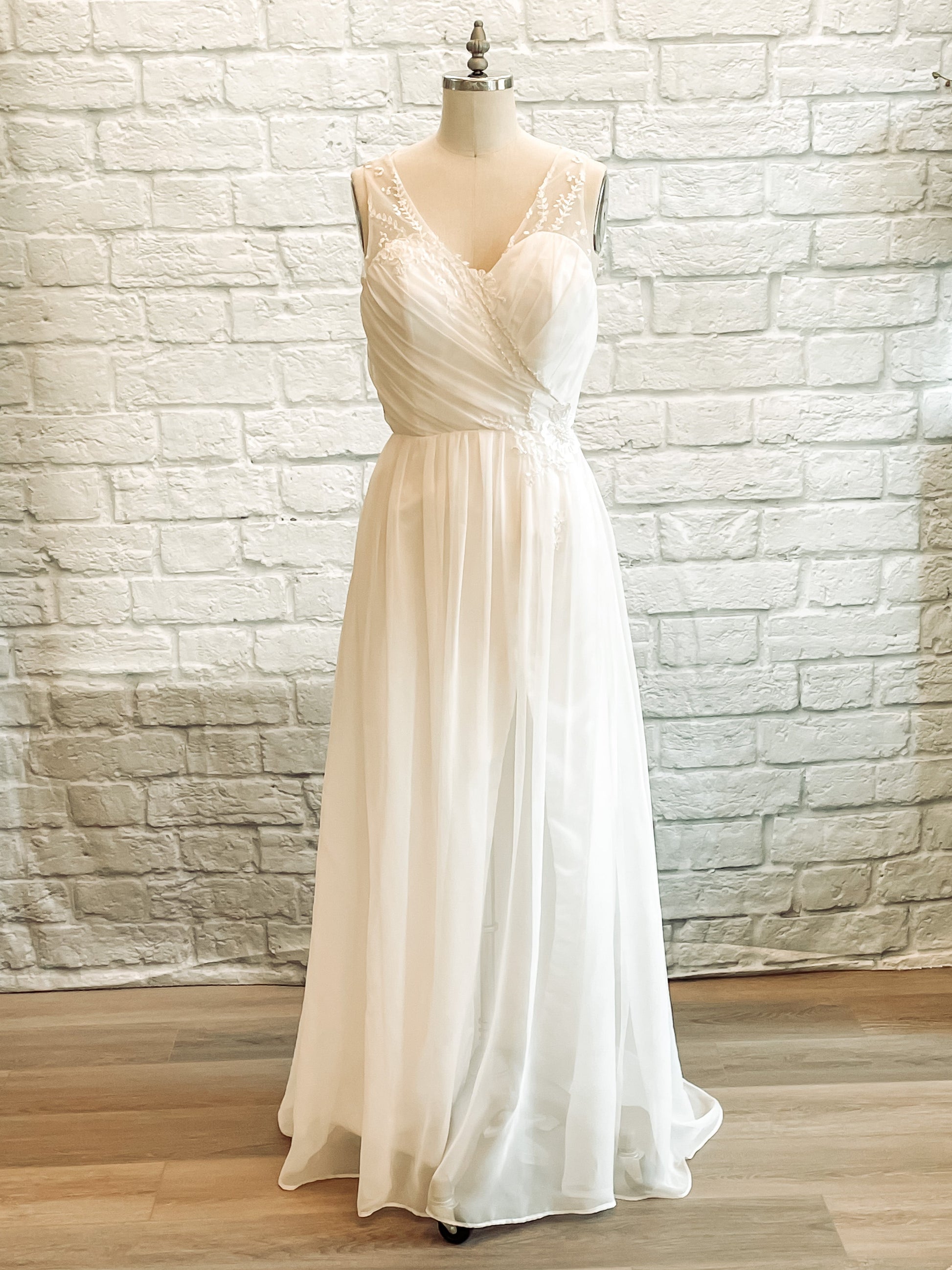 Front view of Odette wedding gown with draped chiffon bodice and faux wrap skirt