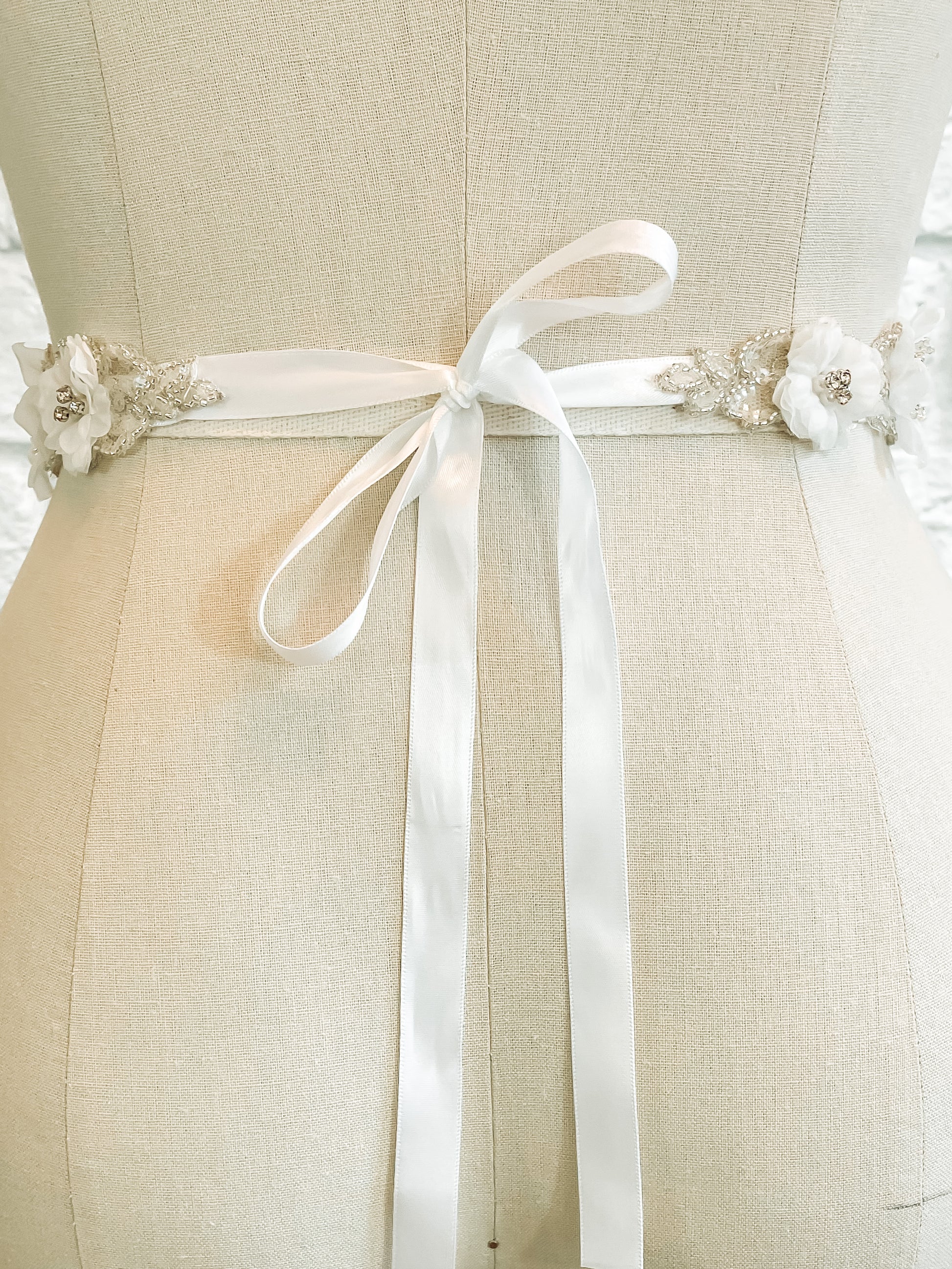 Back view of the Heidi bridal belt on a mannequin; the is belt tied in a bow with soft ribbon tails.