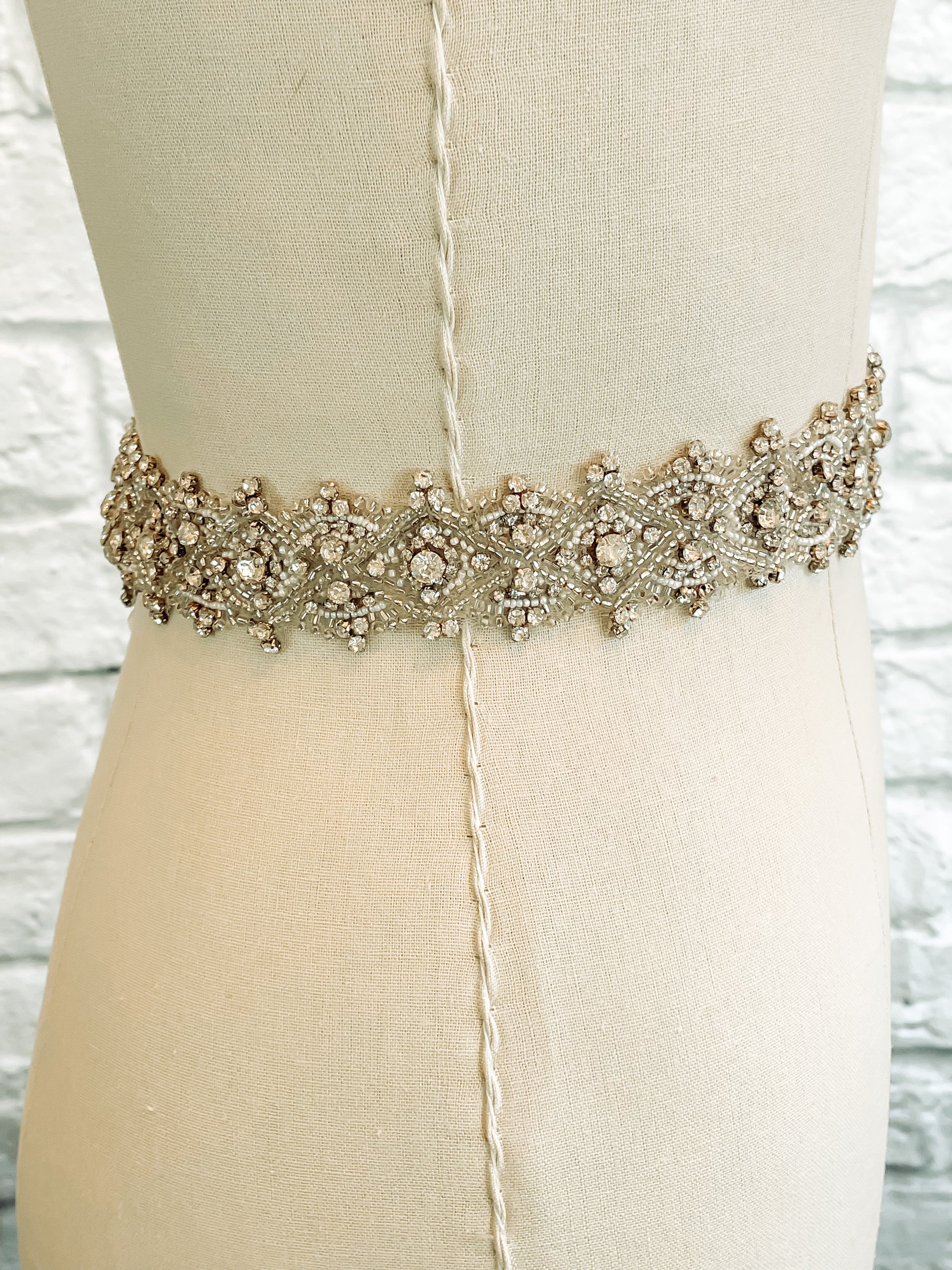 side view of Glam rhinestone and beaded bridal sash on mannequin – Art Deco belt detail.