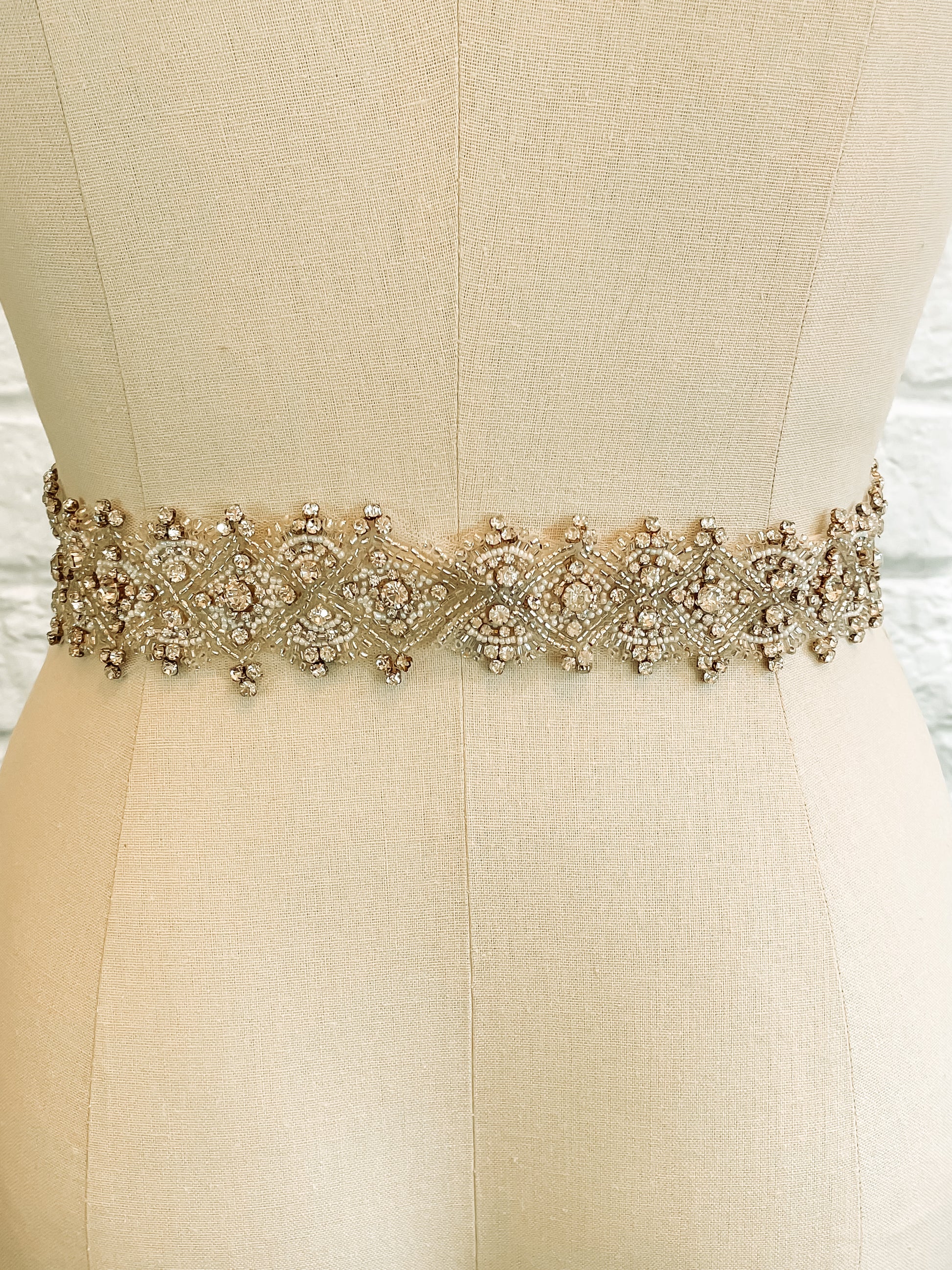 Sasha bridal belt on a mannequin – Back view of Sasha wedding belt – clear snaps and seamless finish