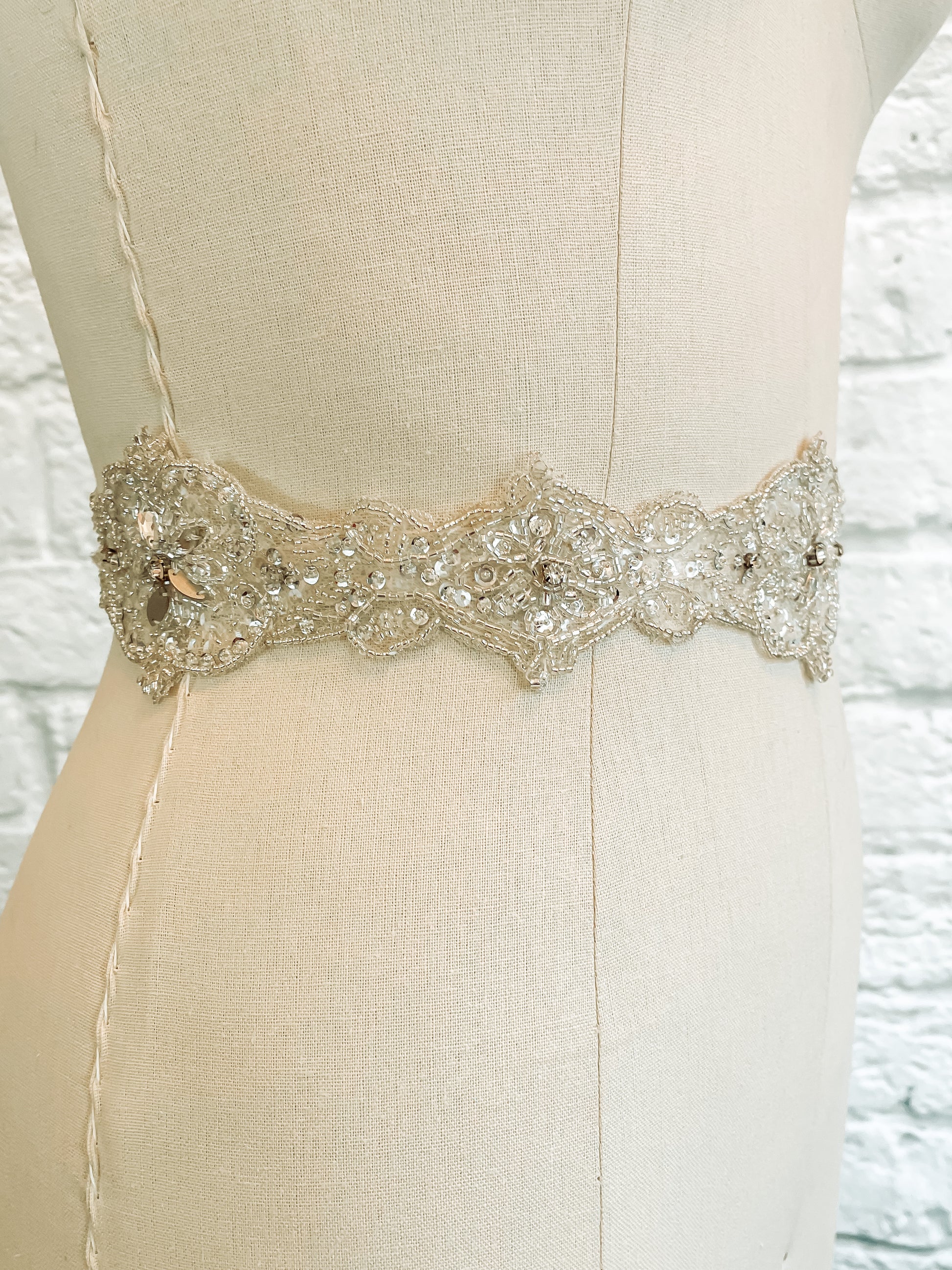 side shot of Noelle bridal belt featuring elegant champagne beading and sequin accents