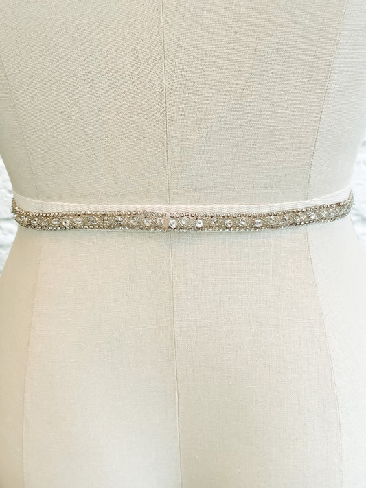 The back of the kelly belt on a mannequin; half-inch Kelly bridal belt showing intricate bead and rhinestone pattern with the seamless hidden snap closure.