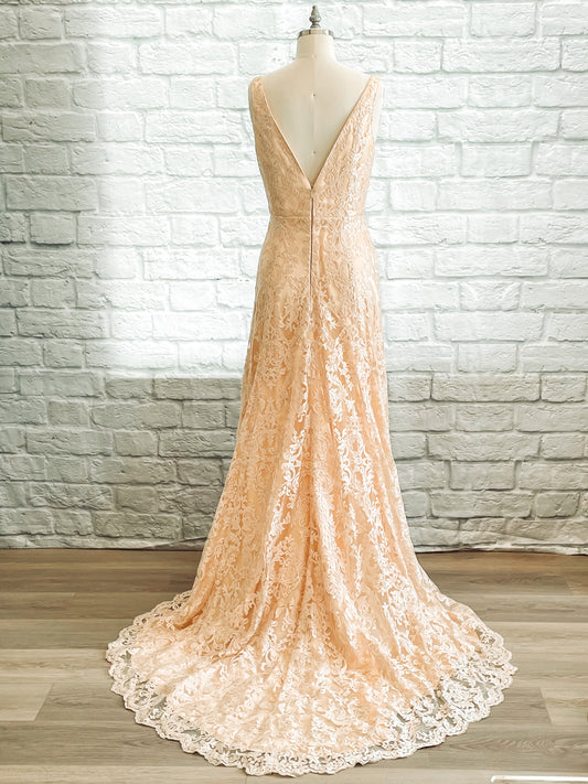 Full back view of the Margaret; a V-back sequined lace gown with scalloped train, shown here in champagne.
