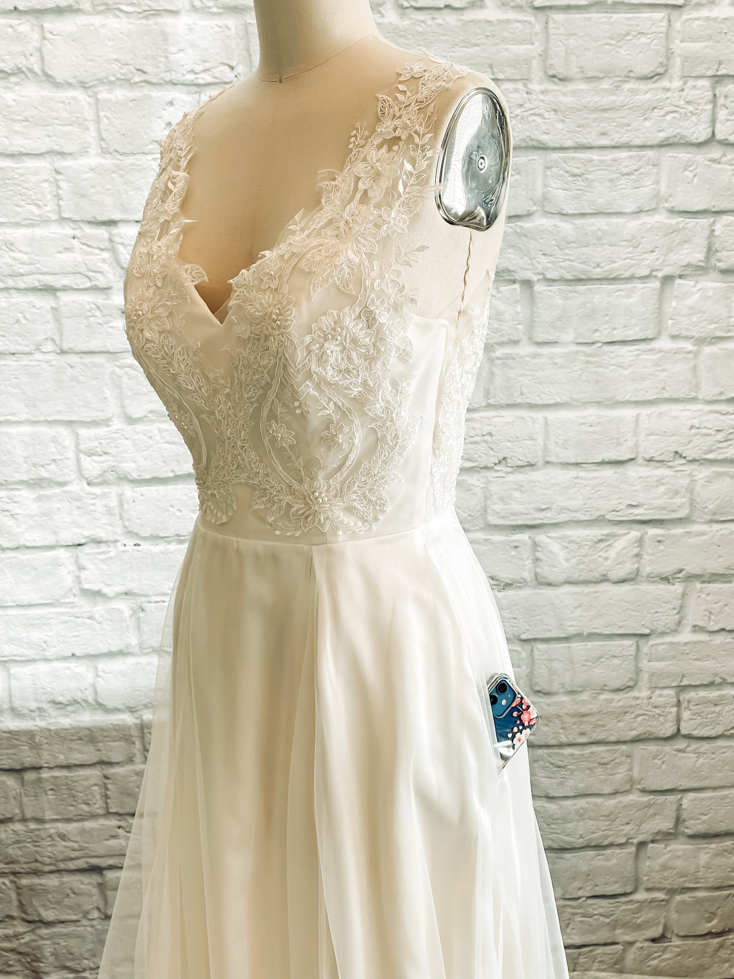 ¾ angle shot of the Marie gown from the front showing off a phone poking out of the hidden side seam pokcet.