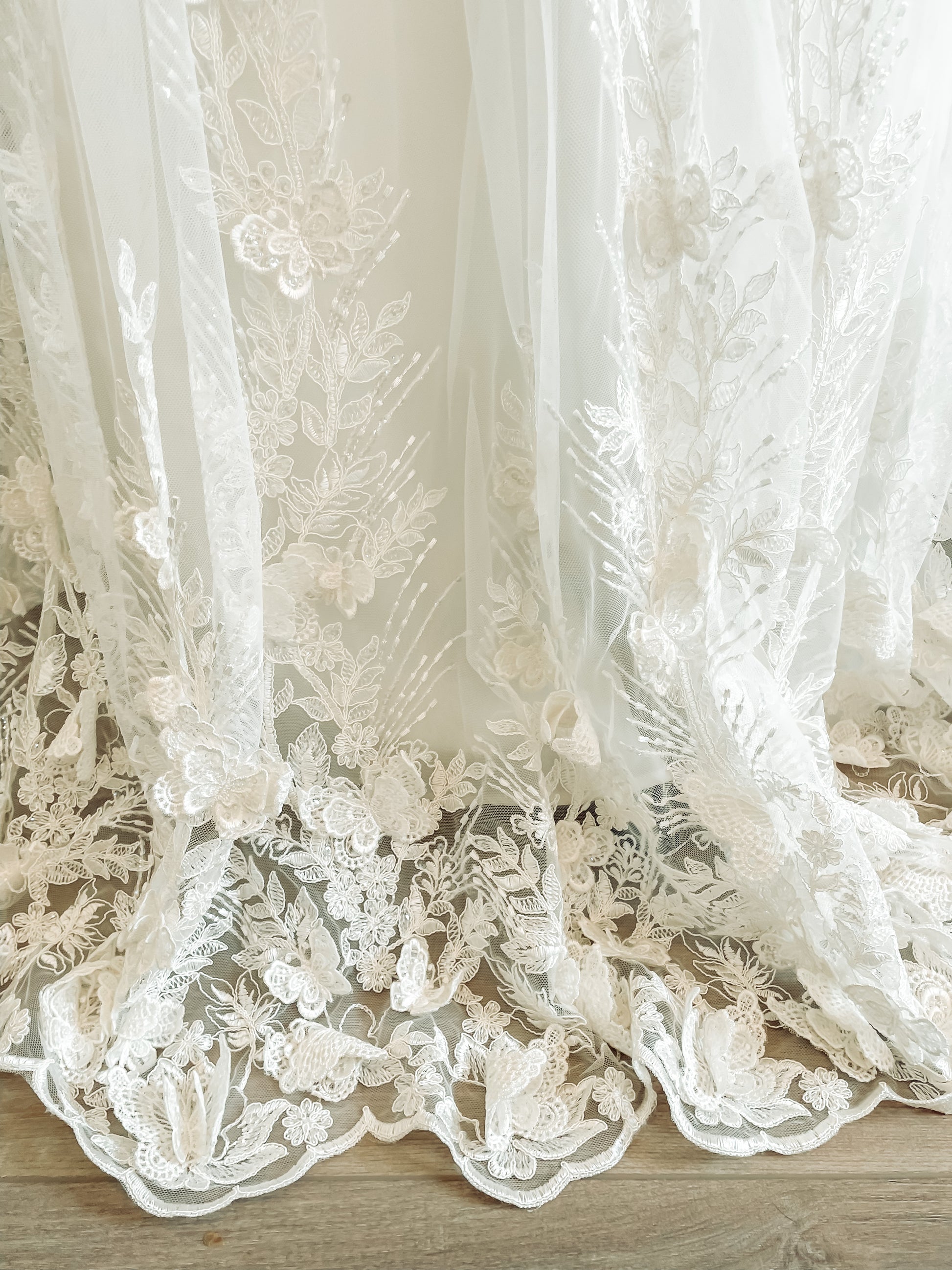 Scalloped lace train extending 10 inches from hem.