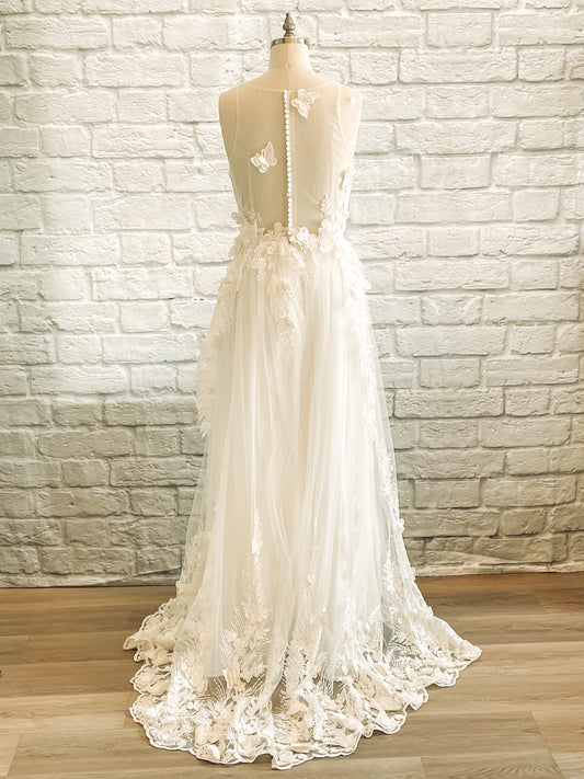 full back view of jacqueline gown with Illusion back with satin buttons and scattered lace butterflies.