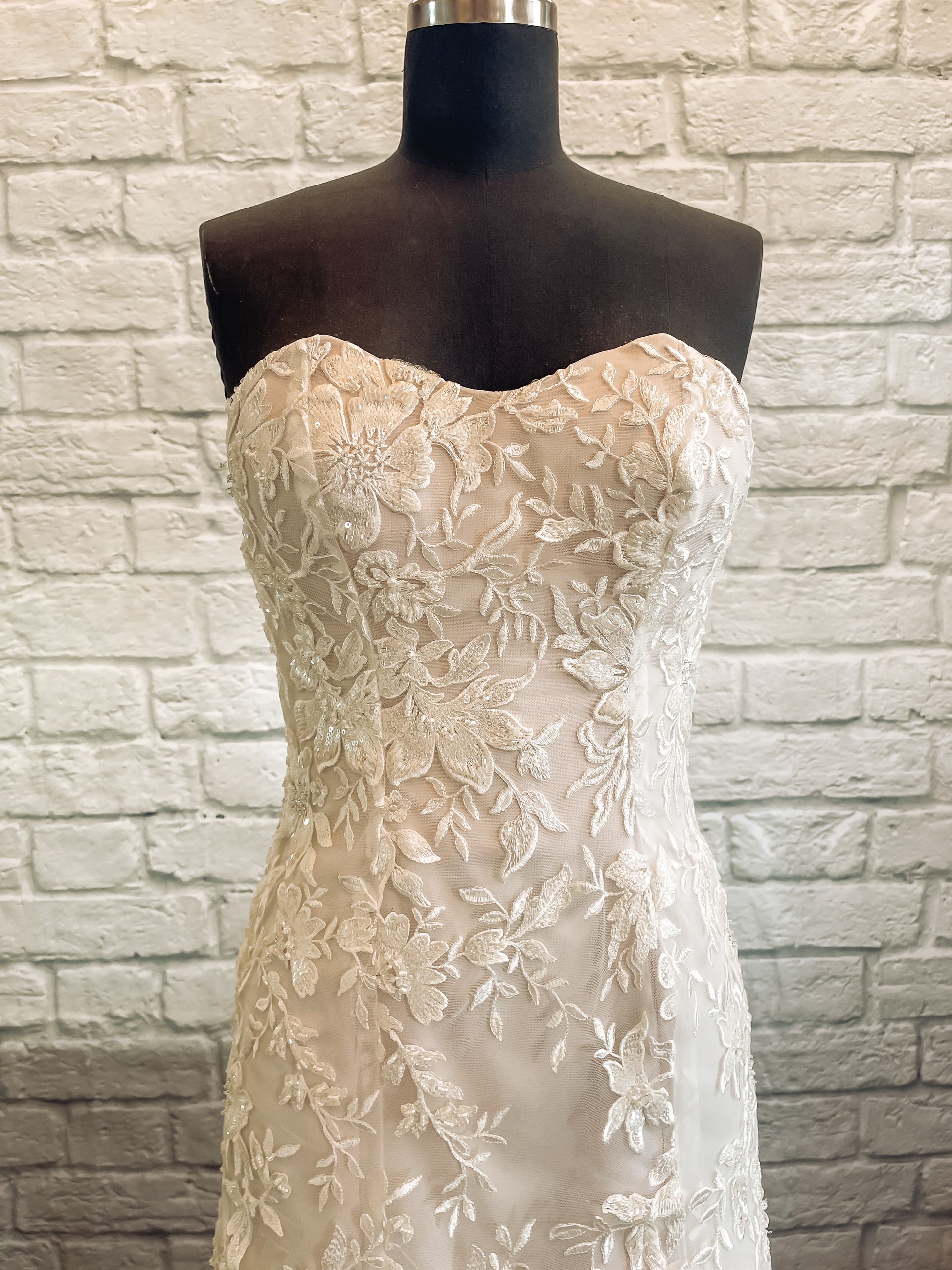 An up close shot of the Sawyer gowns bodice and upper skirt; you can see the beaded floral lace with sequins and pearls.