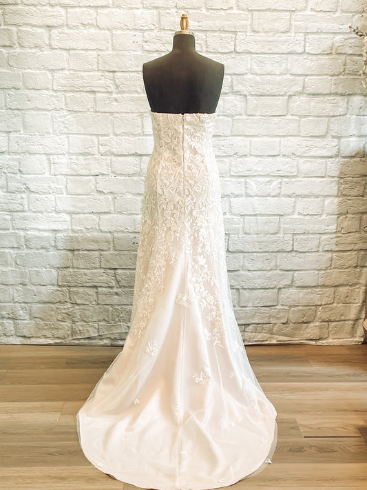 A full length back view of the Sawyer gown with a Strapless straight-across back and 21-inch train detail.