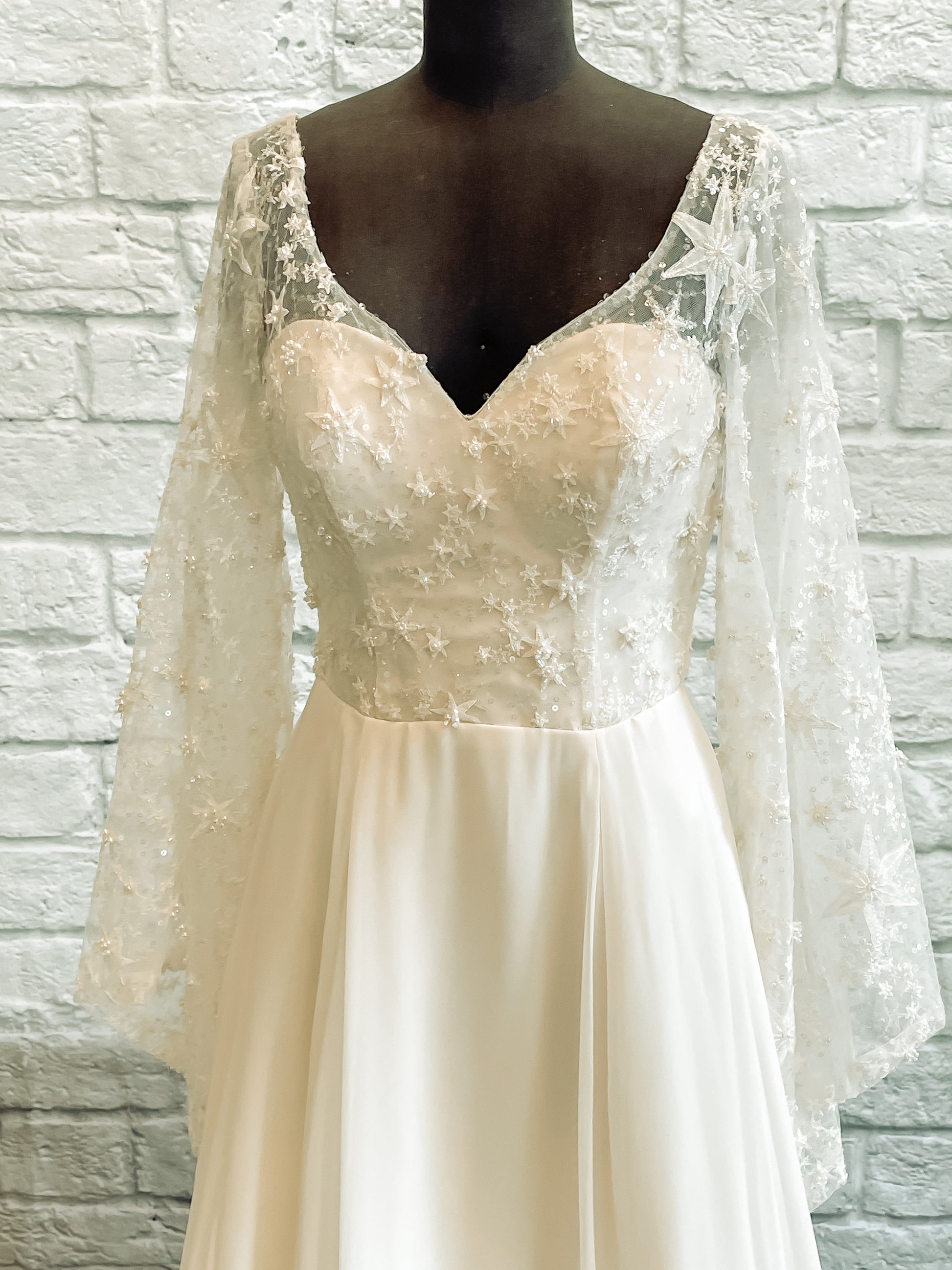 Close-up of Novelli gown bodice showing beaded star lace and sweetheart neckline