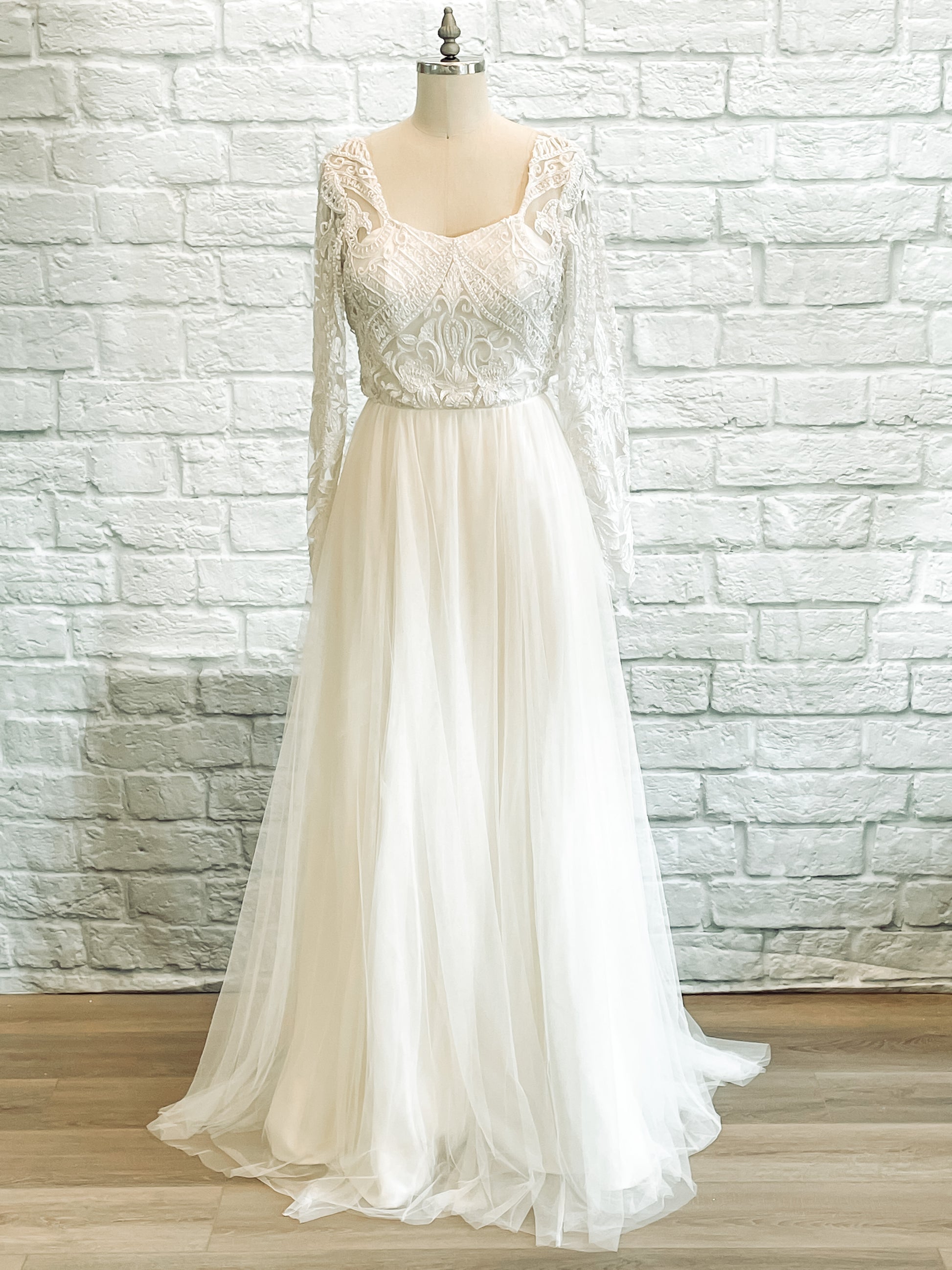 Full front image of Farrah gown on mannequin, showing long lace sleeves, square neckline, and soft tulle skirt