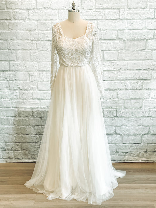 Full front image of Farrah gown on mannequin, showing long lace sleeves, square neckline, and soft tulle skirt