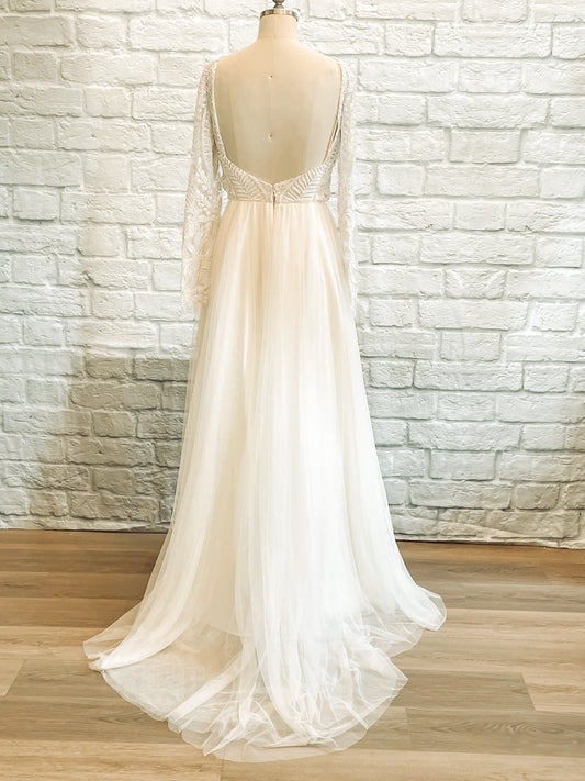 Rear view of Farrah wedding dress highlighting low square back, satin base, and gentle train