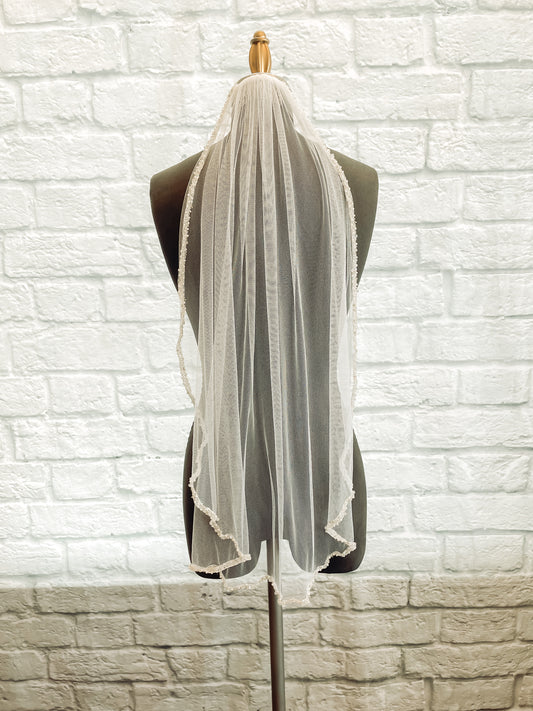 A full length shot of the lena veil in a fingertip length; the veil is displayed on a mannequin.