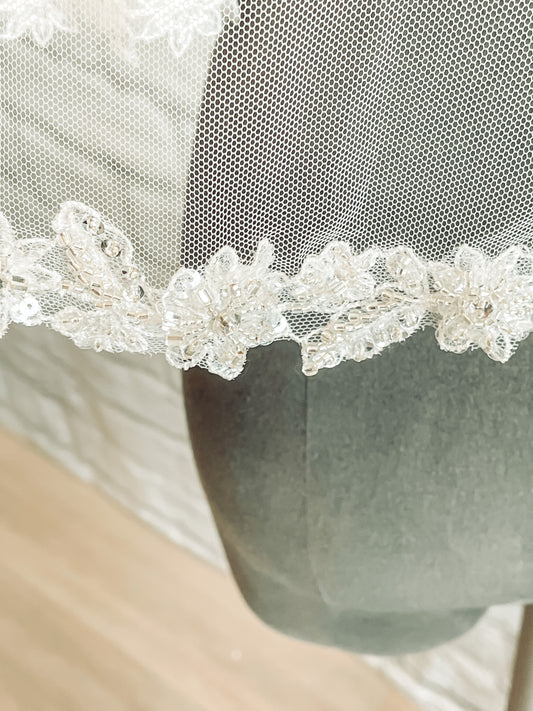 Close-up of glittering lace trim on Haven veil