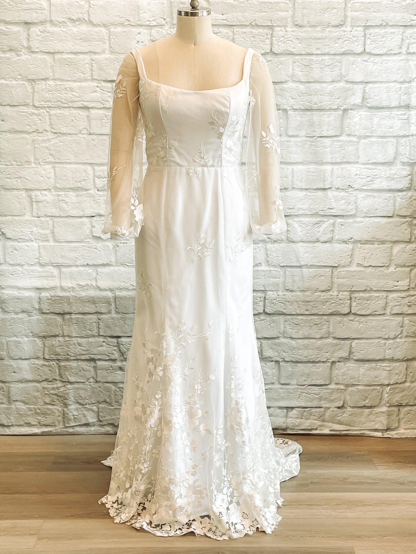 Violet gown on a mannequin showcasing the full front view, square neckline and fit and flare silhouette