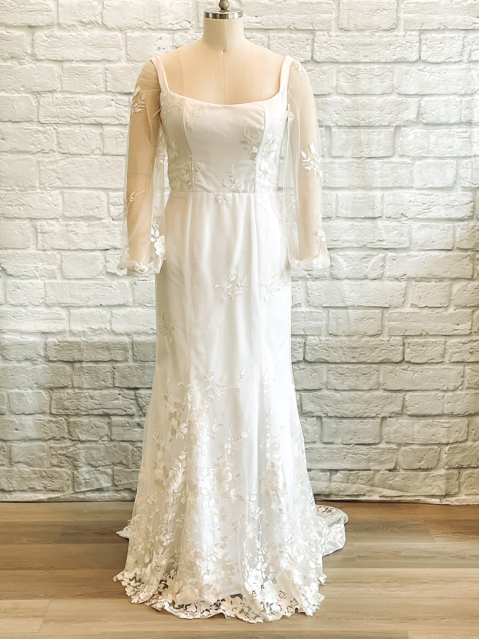 Violet gown on a mannequin showcasing the full front view, square neckline and fit and flare silhouette
