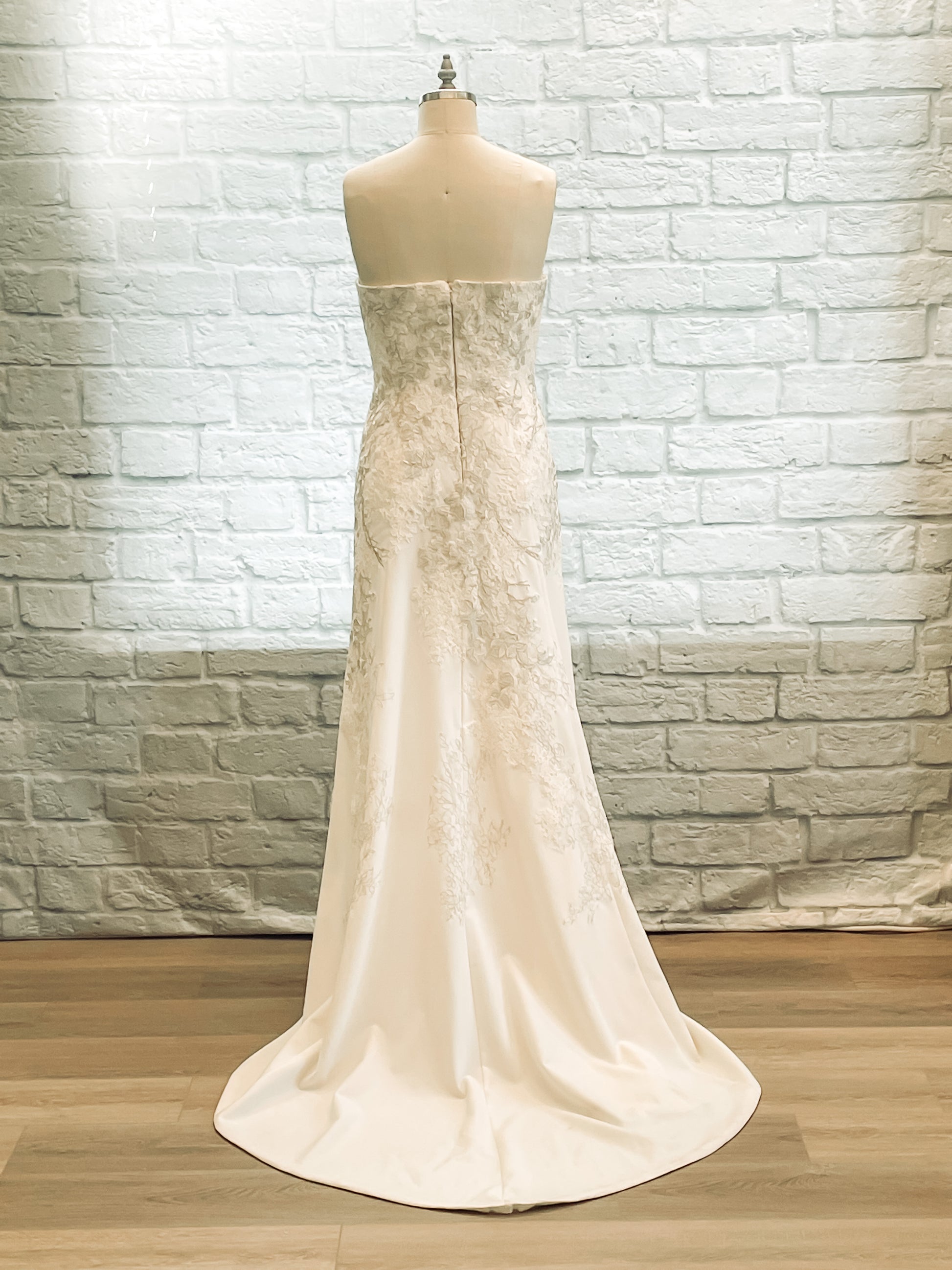 Back of gown showing smooth crepe flare and 18-inch train.
