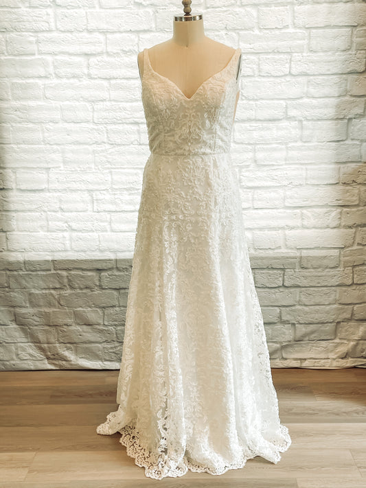 Full front view of the Margaret beaded lace trumpet wedding gown with sweetheart-V neckline and illusion side. Shown here in Ivory.