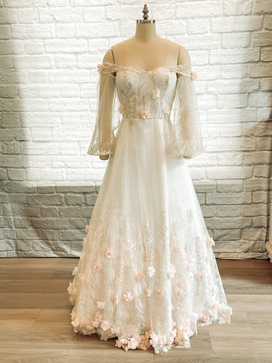 Full front view of the Prue wedding dress on a mannequin with sweetheart neckline, bishop sleeves, and 3D floral lace.