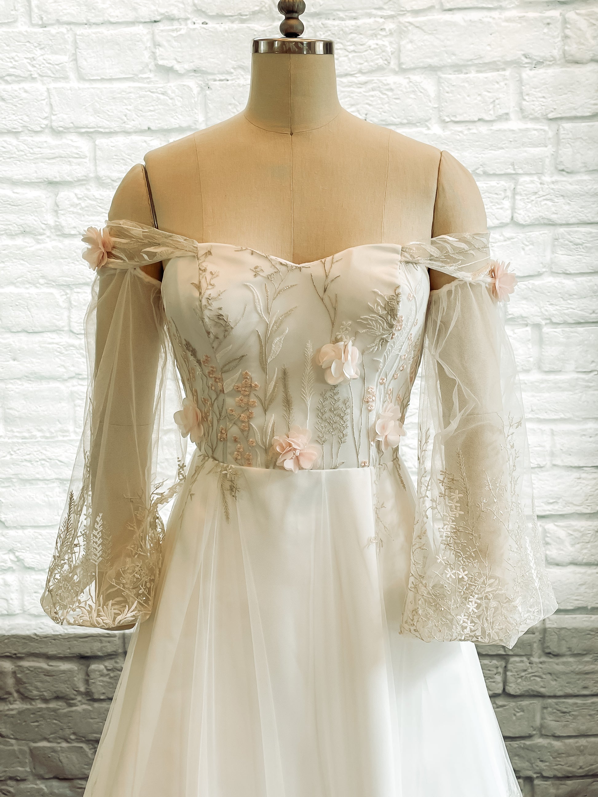 Close up view of the prue front bodice with Metallic thread lace and beaded chiffon flowers on sweetheart neckline.