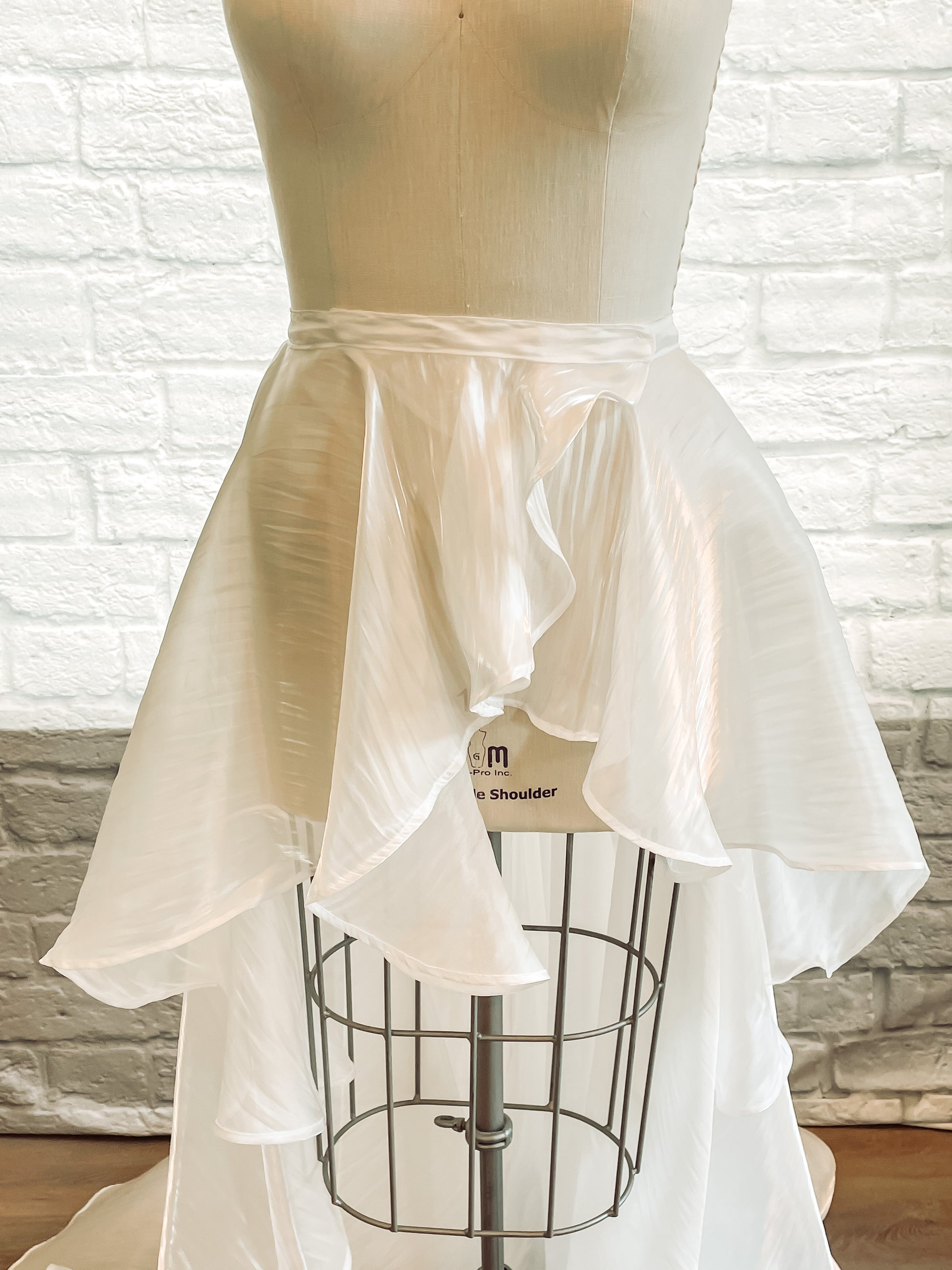 Detail shot of waistband and front of skirt on the Amber removable skirt, featuring hidden snaps and hook-and-eyes for a seamless finish