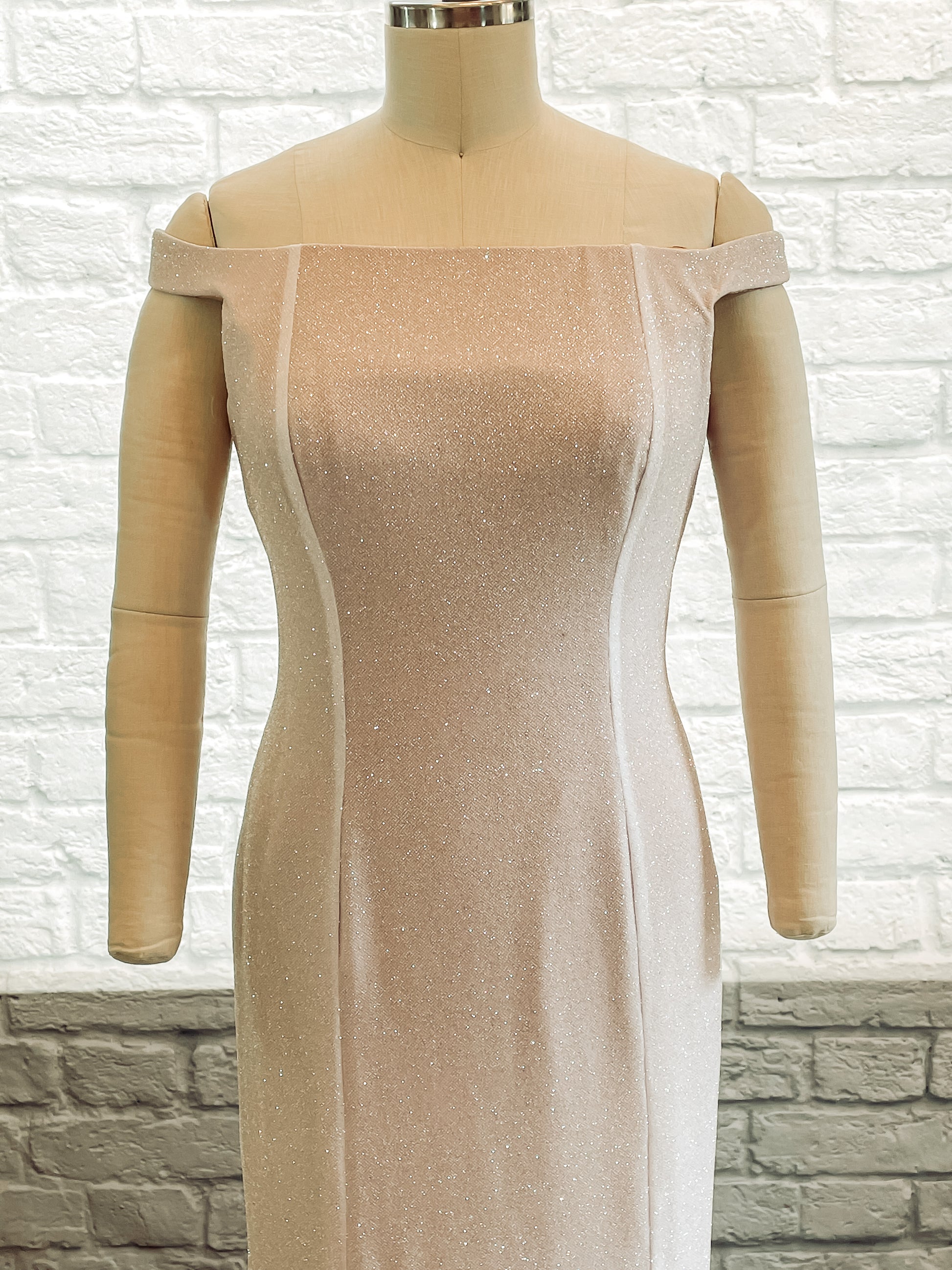 Close-up of the front bodice and glitter crepe fabric on Alora gown showing sparkle detail.
