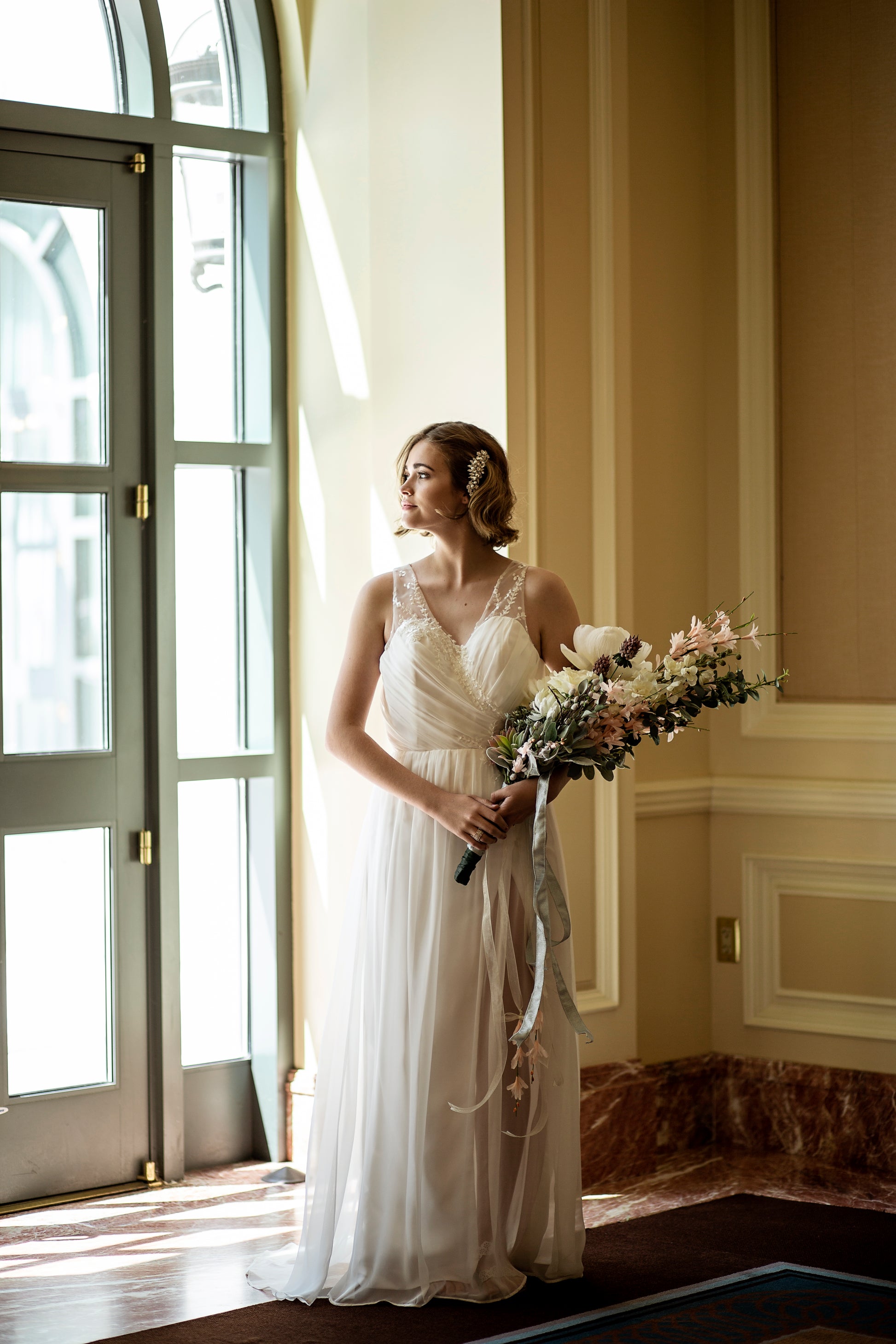 Bride wearing Odette gown showing sweetheart neckline with pleated chiffon overlay on the bodice