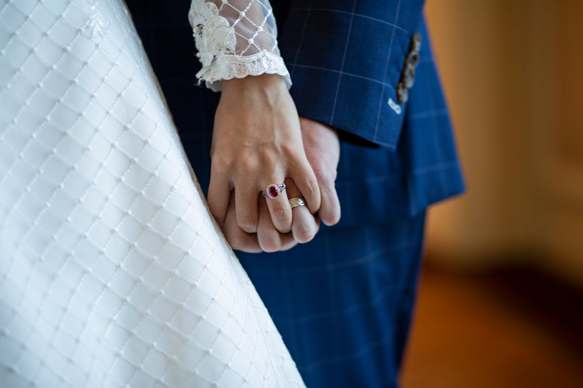 A upclose image of the diamond tulle and sleeve with scalloped edges on the virginina gown.