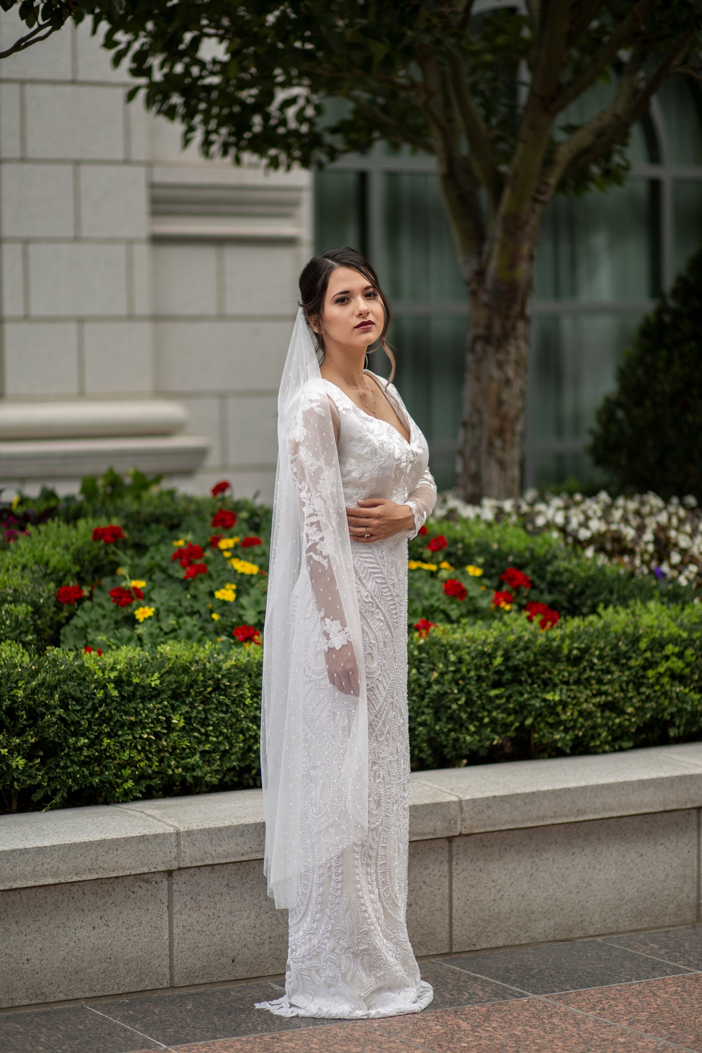 A profile photo of a bride wearing our Octavia gown and Scarlett veil. This photo shows the veil in a waltz length.