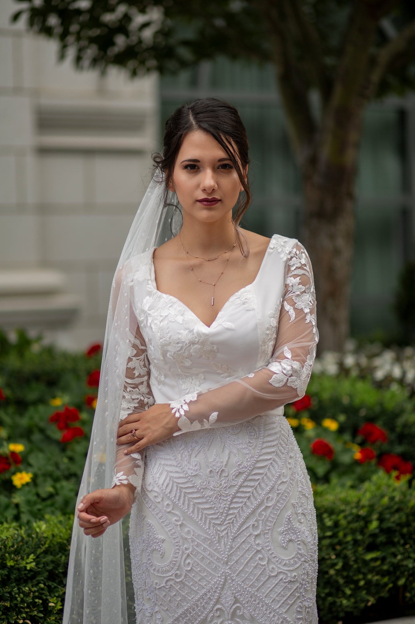 A front photo of a bride wearing the octavia gown and scarlett veil; this sweetheart neckline sheath gown matches beautifully for a highly textured look with the Scarlett veil.