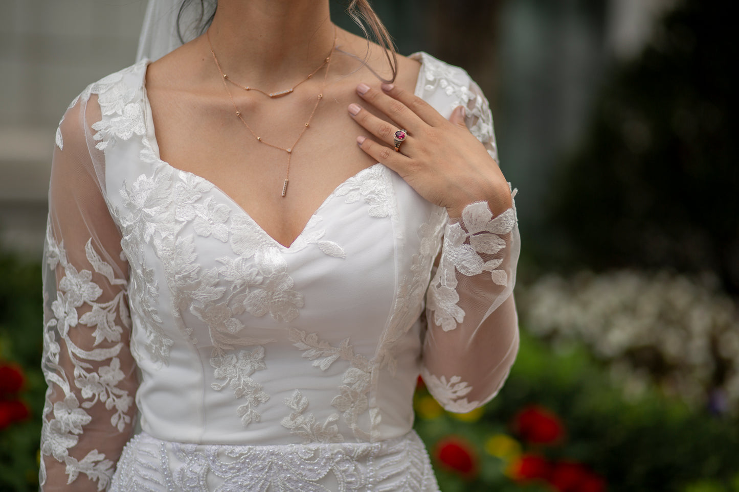 Detail of the bodice and sheer lace sleeves with floral lace along the wrist on Octavia dress