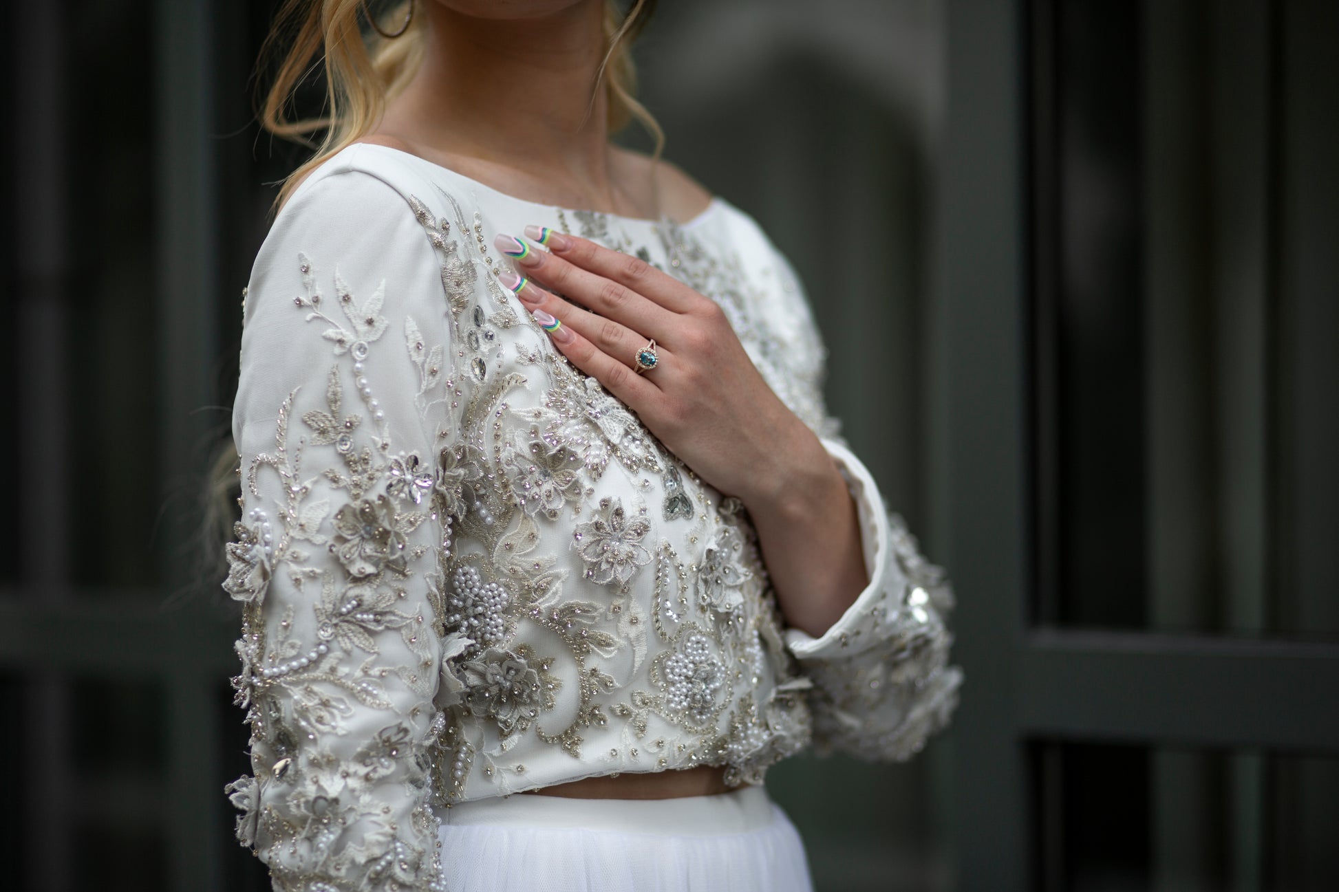 Side profile of the model wearing Ember, highlighting the lace sleeve and floral embellishments.