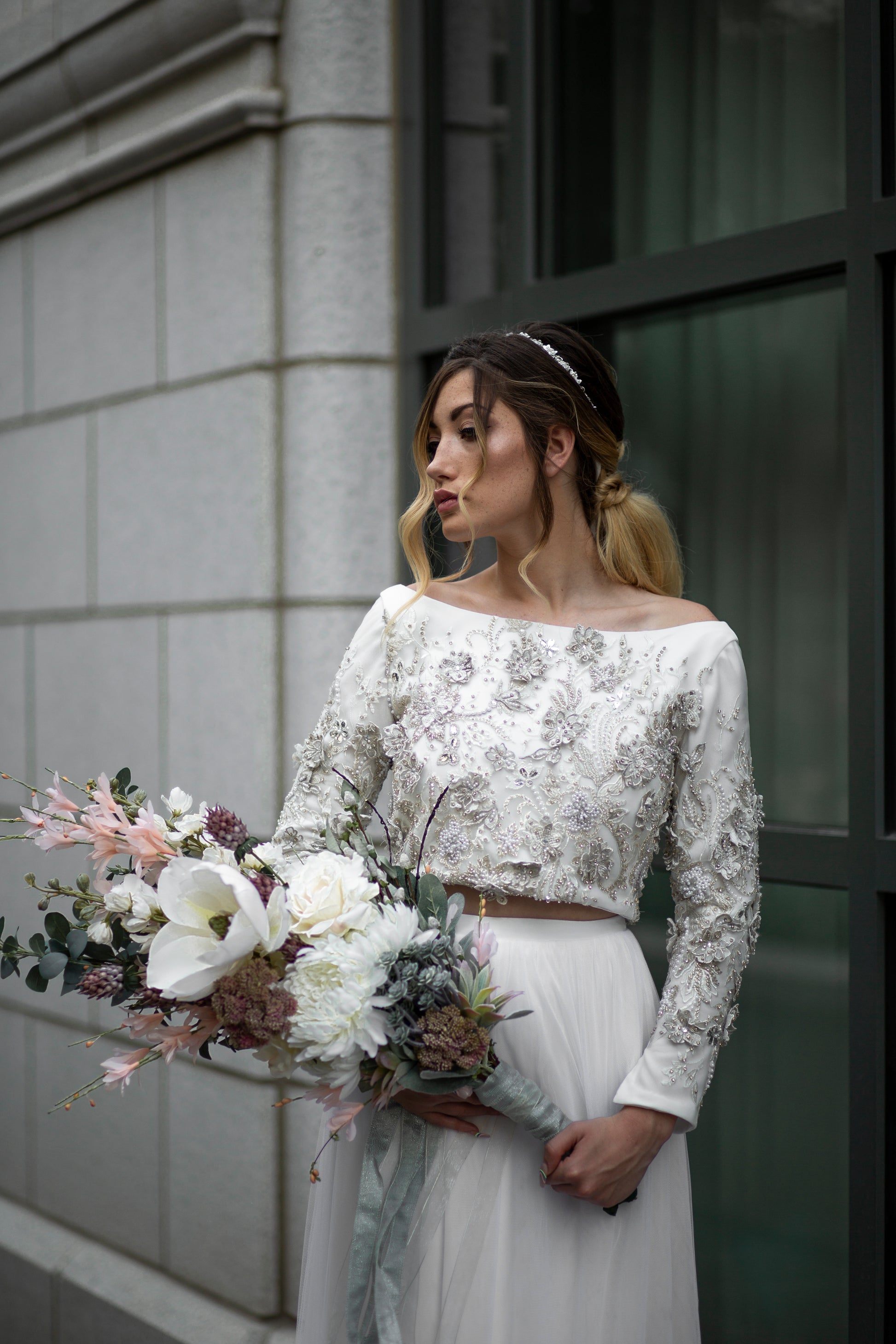 Close-up of the front bodice and top of the skirt. Showing off the 3D floral, long sleeves and boatneck.