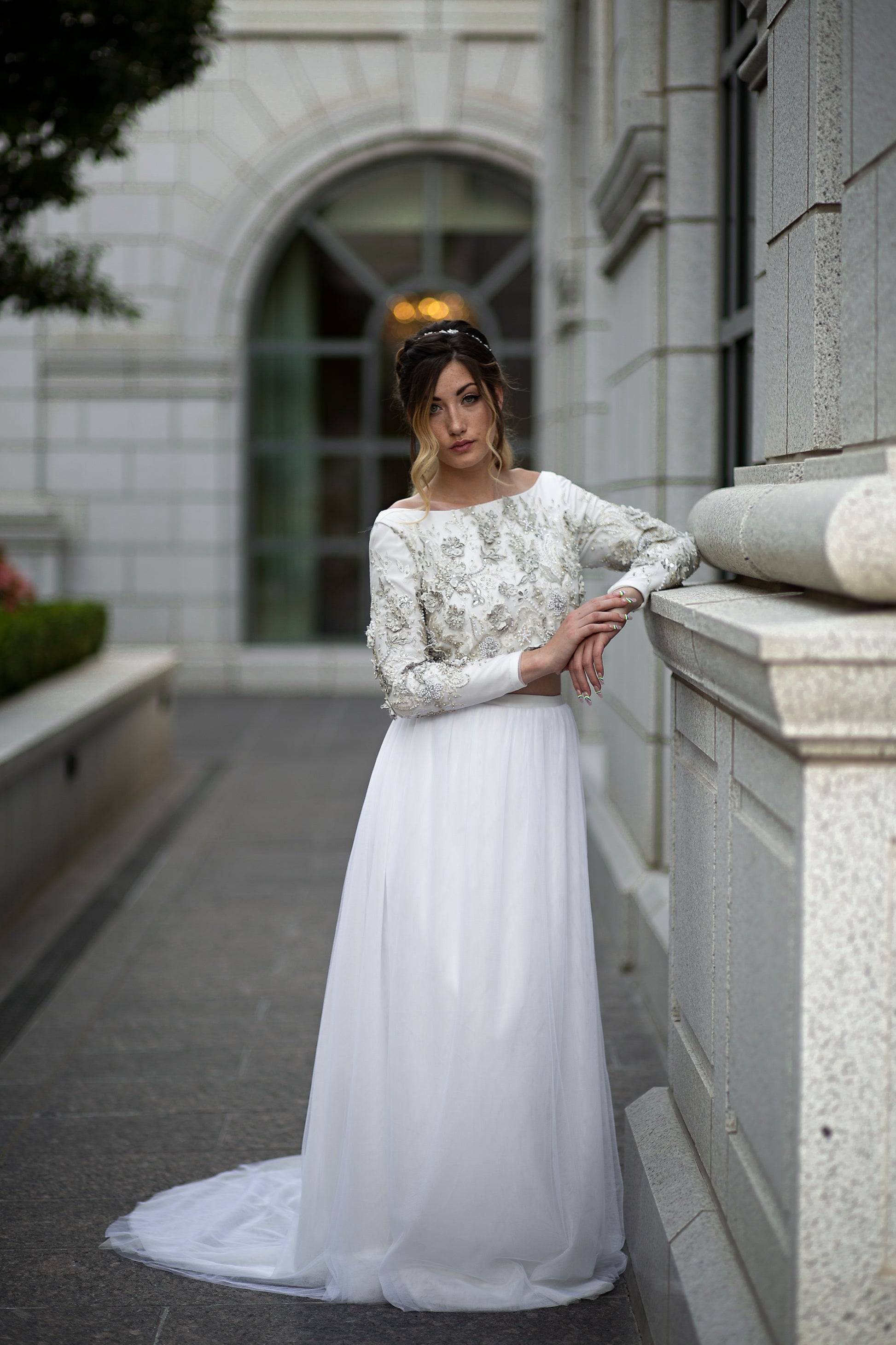 Full front view of Ember on model, showing off the 3D floral lace bodice, soft layered tulle skirt, and train extending behind