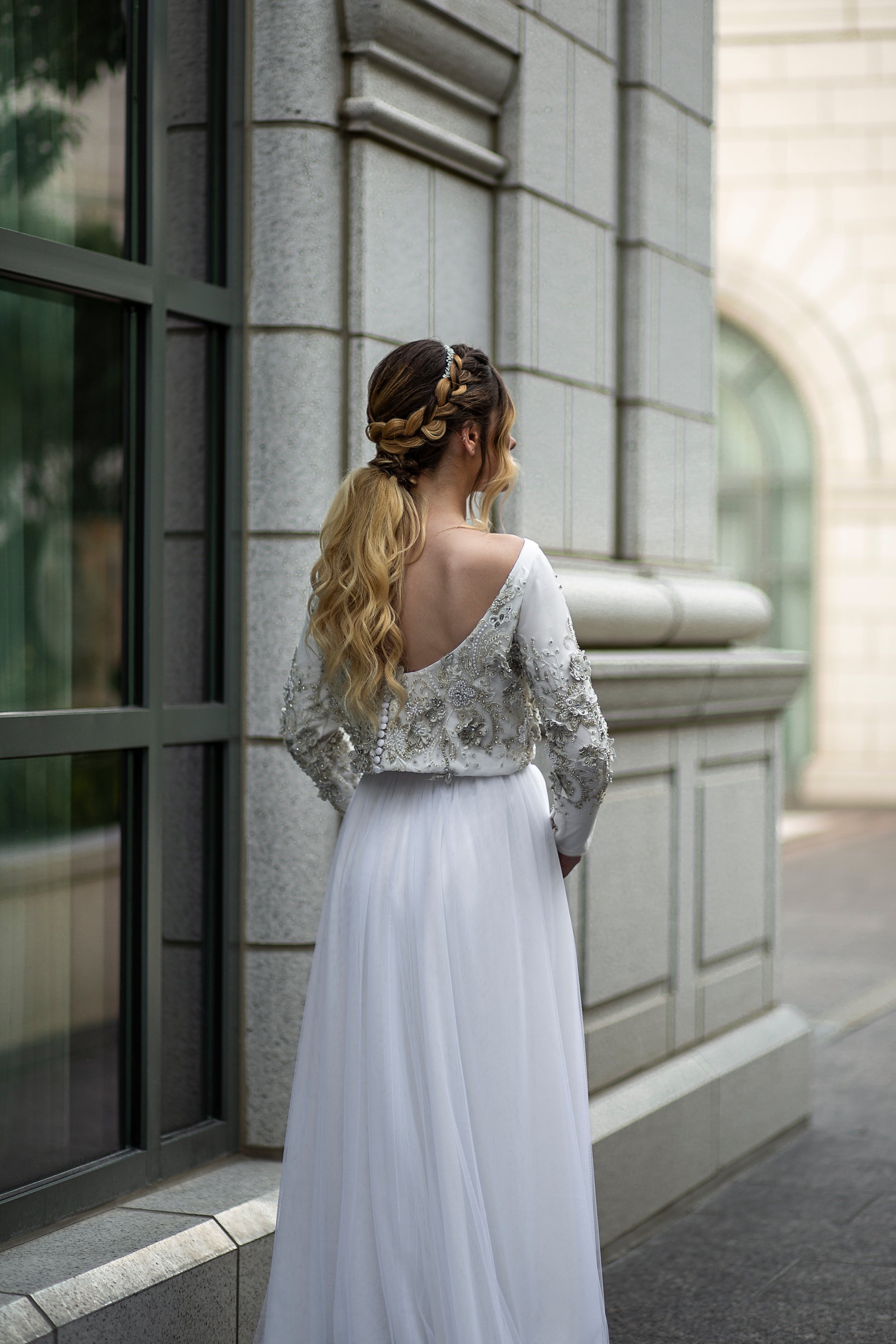 ¾ angle of the back bodice and skirt. Emphasizing the low scoop back neckline and flowy tulle skirt.