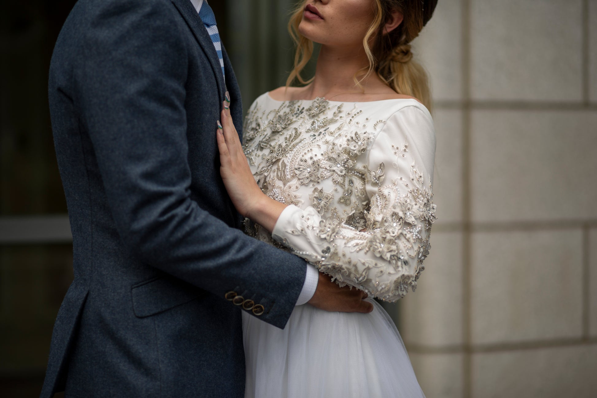 Up close image of a groom holding the bride wearing the Ember bridal set.