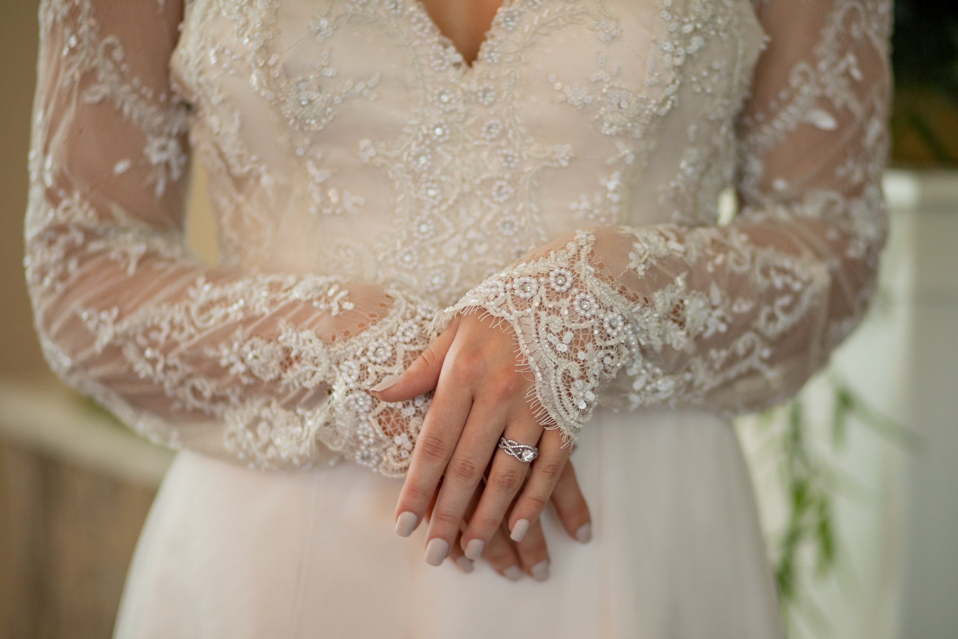 Detail shot of sleeve hem, focusing on eyelash lace scalloping at the knuckles; the lace bodice is slightly out of focus behind.