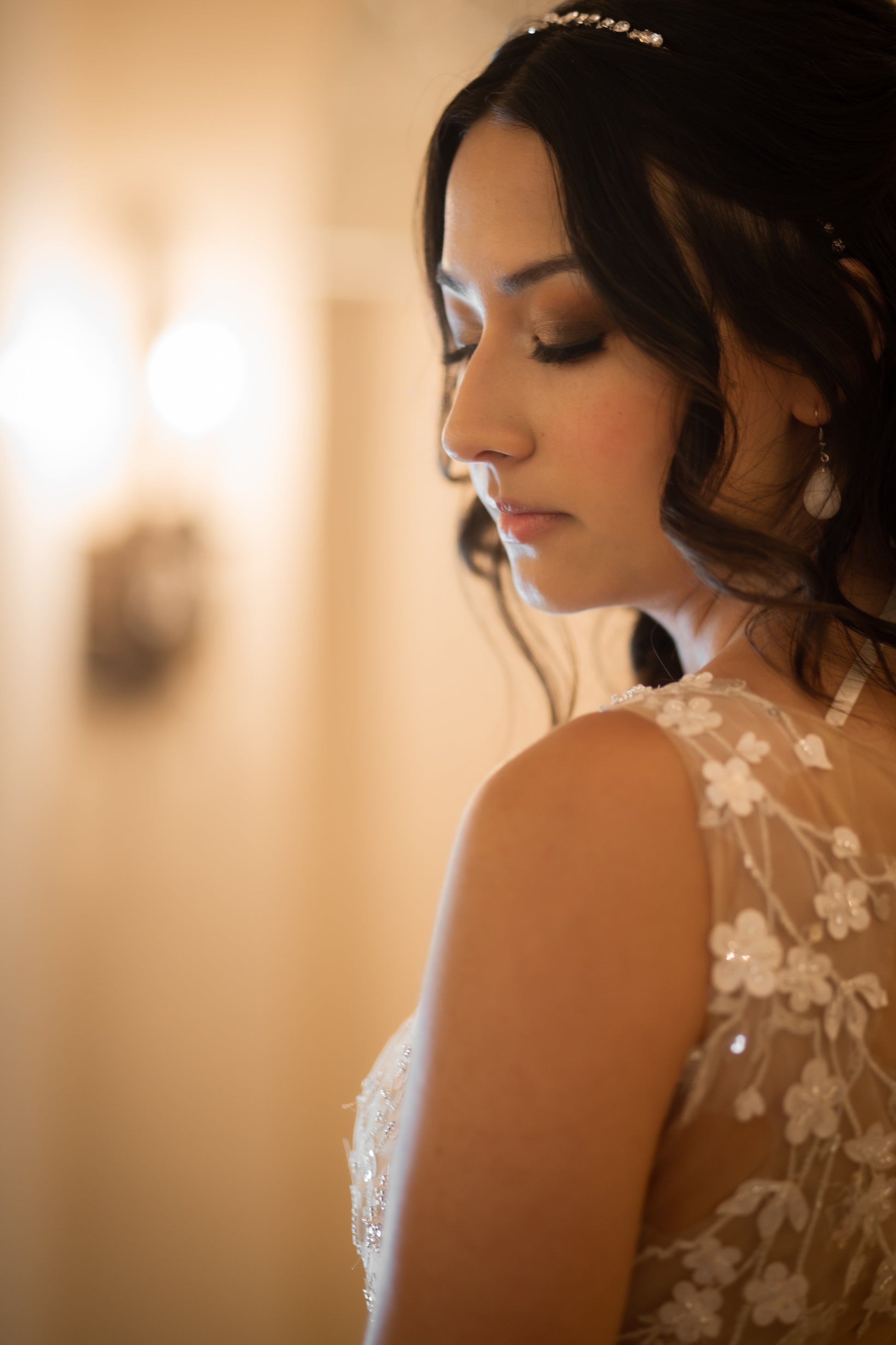 A close up of the shoulder of the lorien gown showing the nude illusion back and champagne lace on a bride.