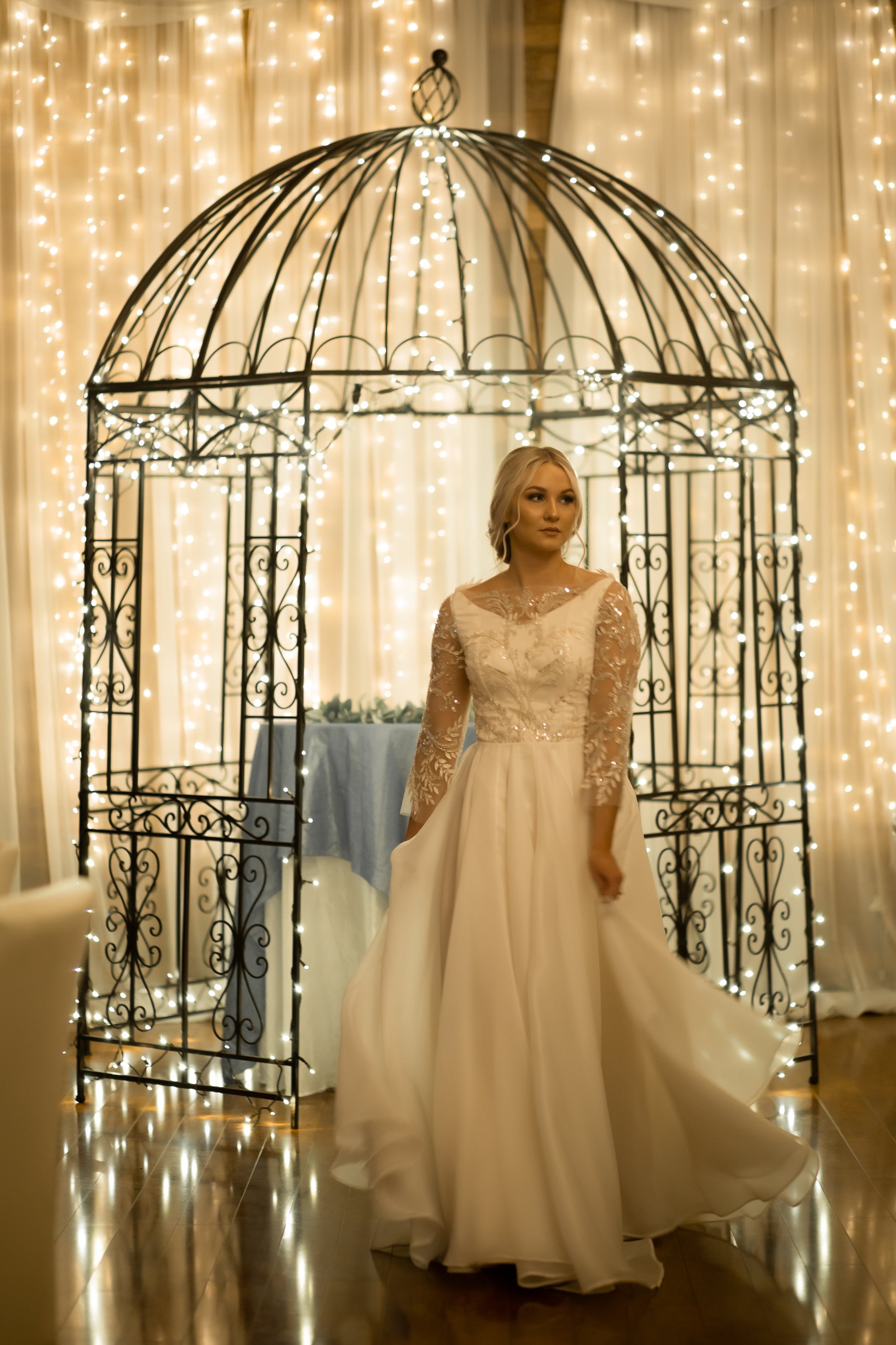 A full length shot of the satin and organza gown, Theodora; from the front we can see the bride moving and the Flowing circle organza skirt.