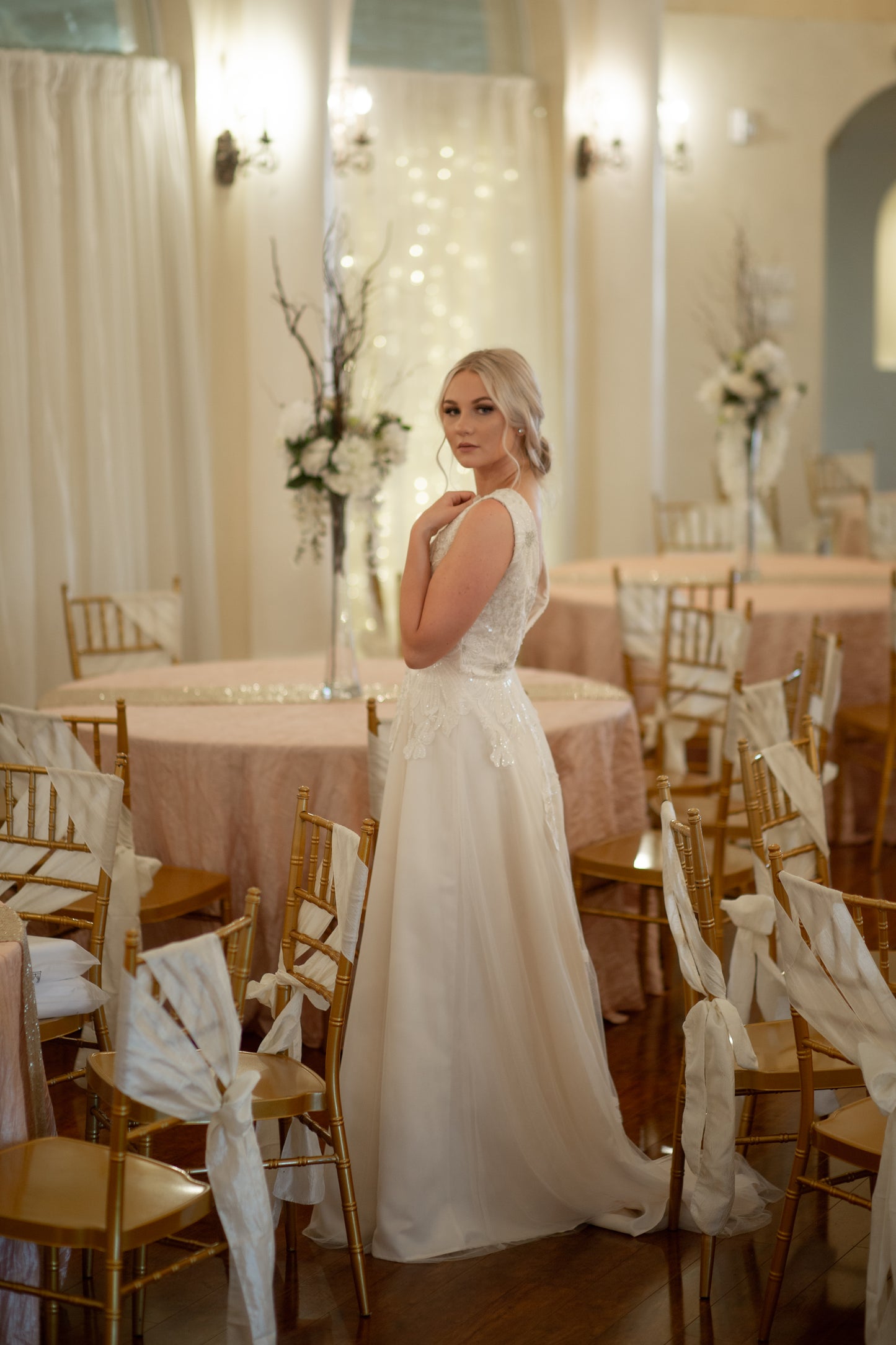 A full side view of the poppy gown, The lightweight A-line tulle skirt flows from fitted bodice for a romantic figure.
