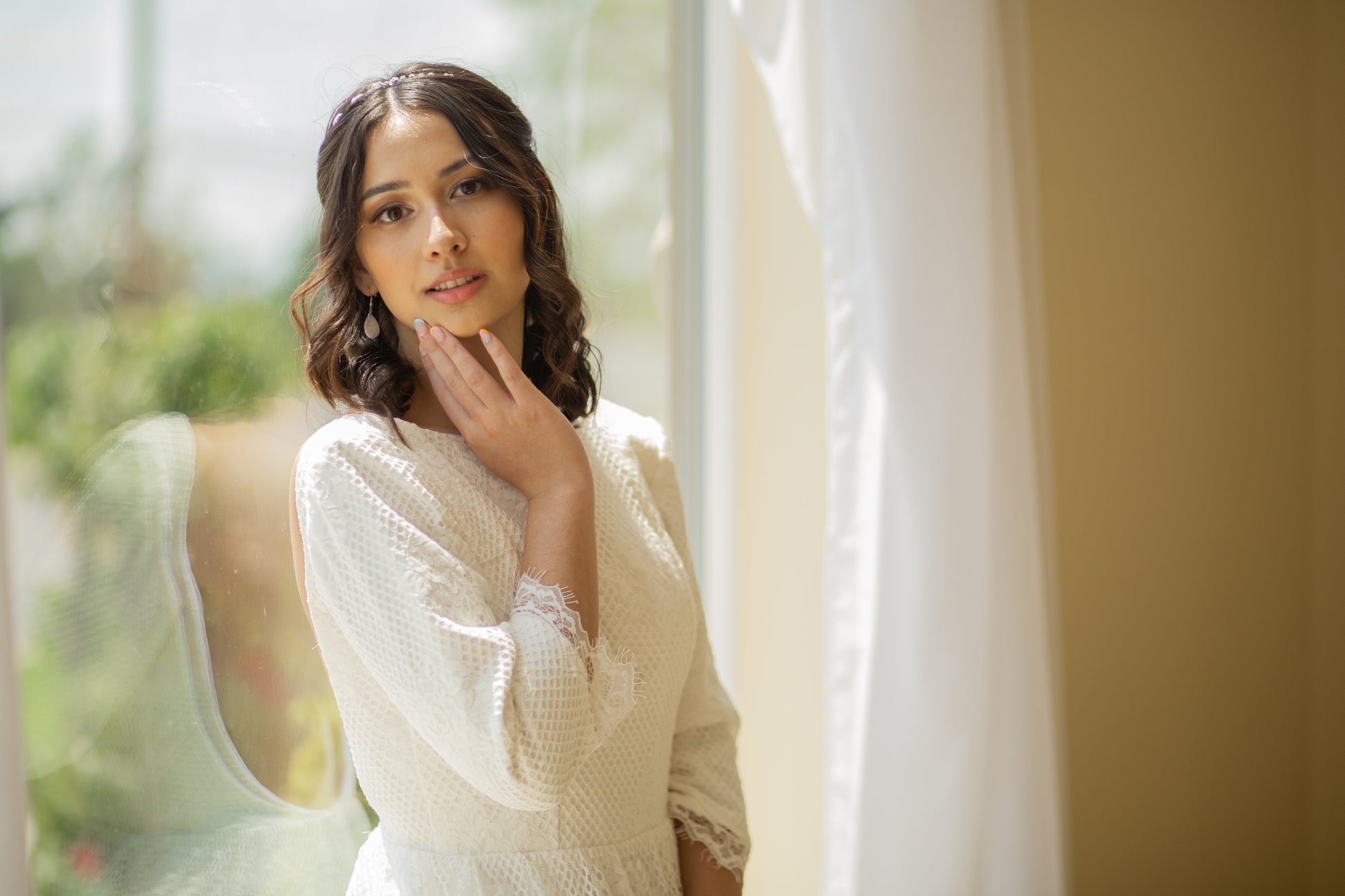 Side profile of the bride in Avabelle gown, showing off the elegant lace, boat neckline and scalloped sleeves.