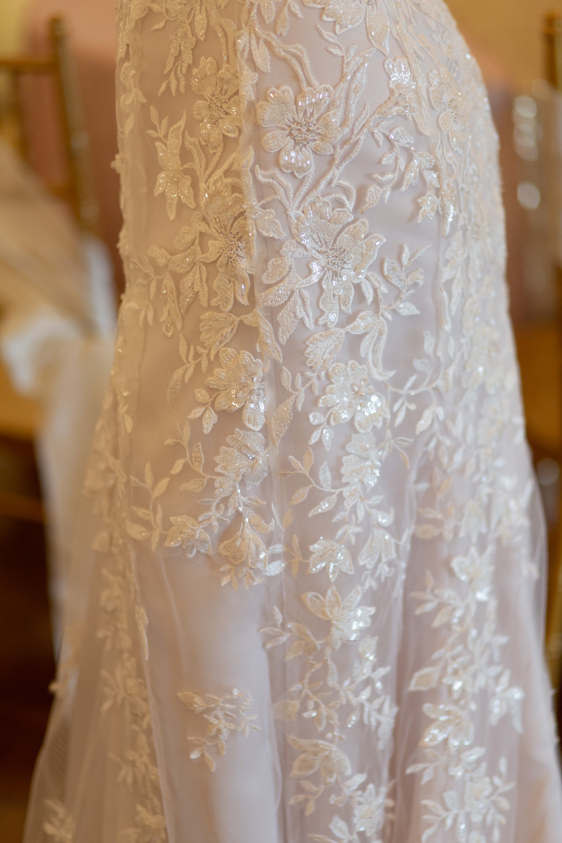 The skirt of the Sawyer gown; focusing on the trumpet silhouette showcasing curve-accentuating fit and fading of the lace.