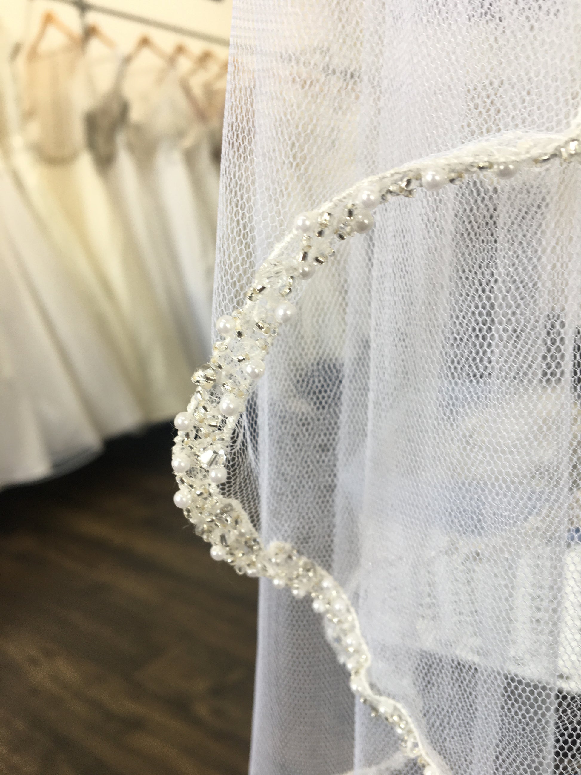 an upclose look a the Shimmering calf length veil with lace trim, Lena.