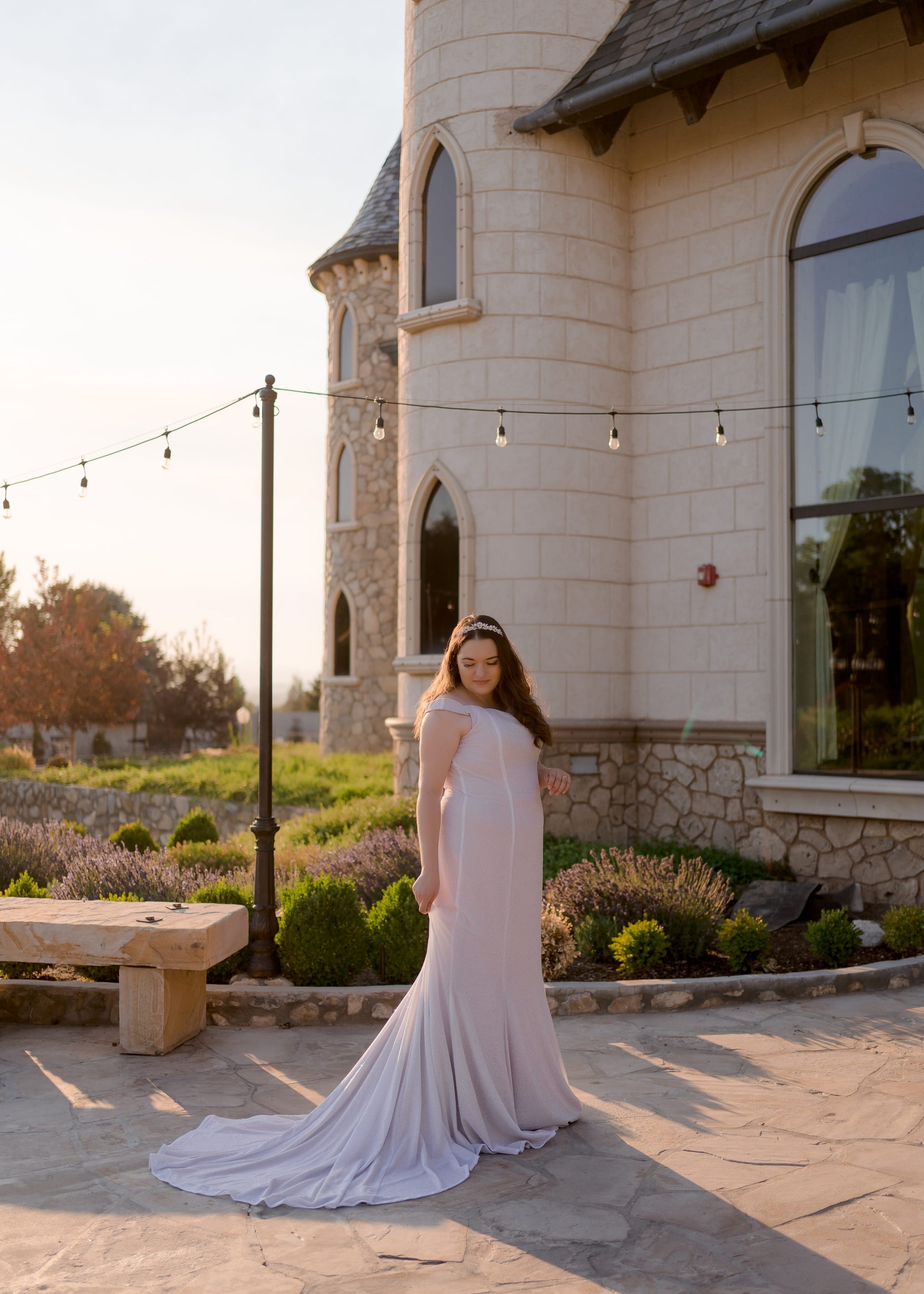 Side profile of bride in Alora dress highlighting curve-hugging trumpet silhouette
